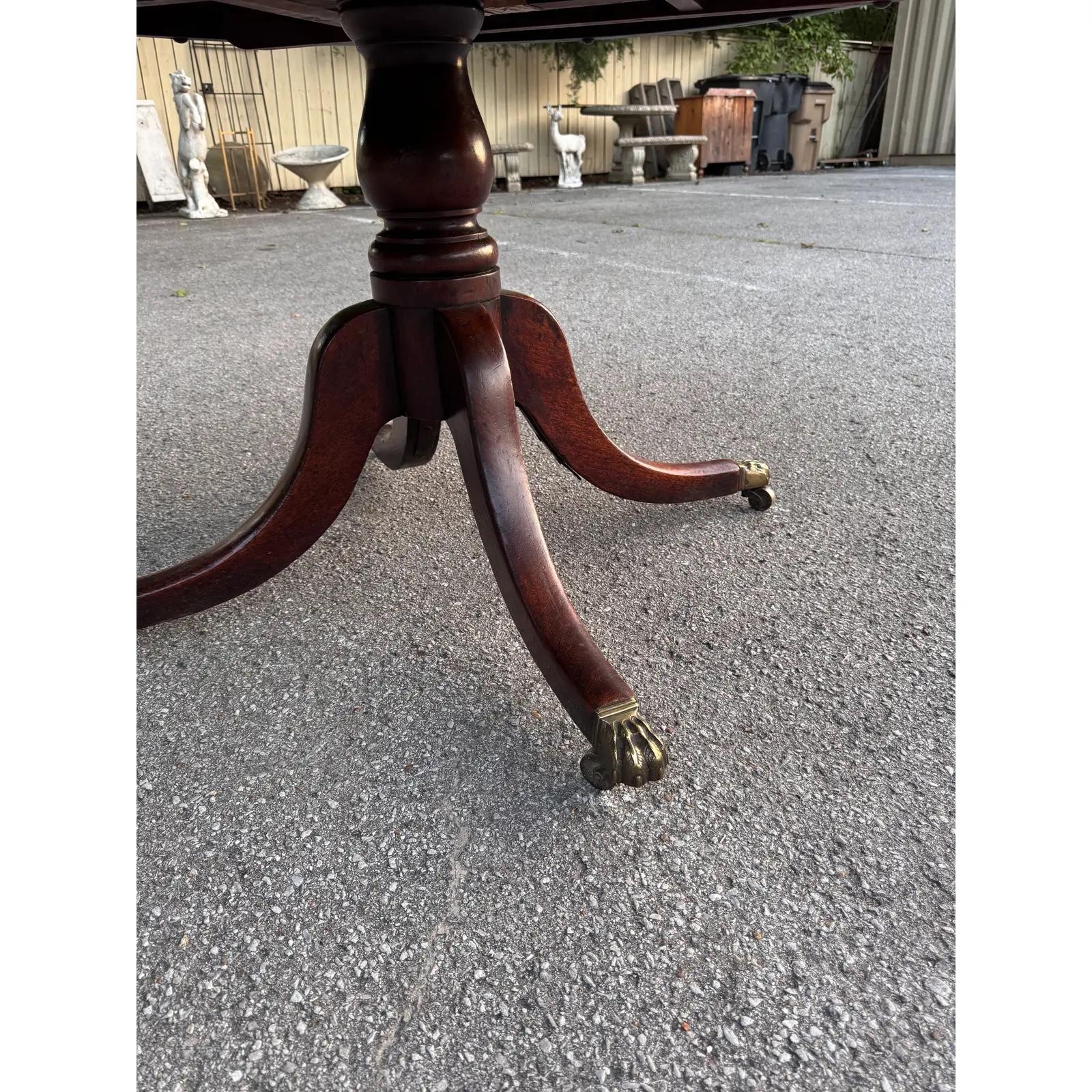This is a beautiful all-original English dining room table from the late 19th century. Brass feet with brass wheels with that beautiful patina make this an excellent table all around. Antique tables like this are extremly hard to find  especially in