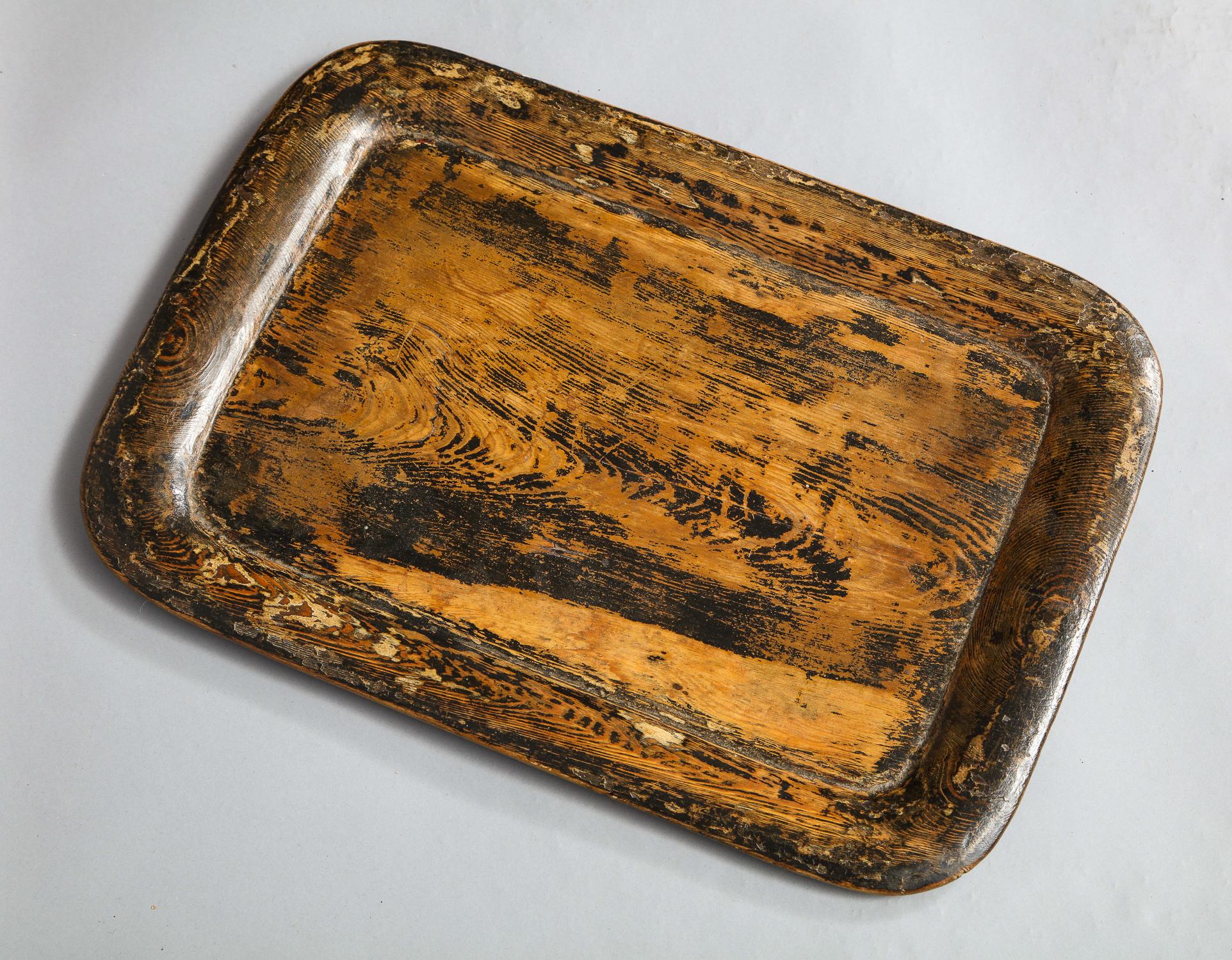 Interesting early 19th century English Folk Art carved and painted wooden tray with traces of original paint. This tray is a charming example a country craftsperson attempting to imitate a more high style lacquer or papier mâché tray using the