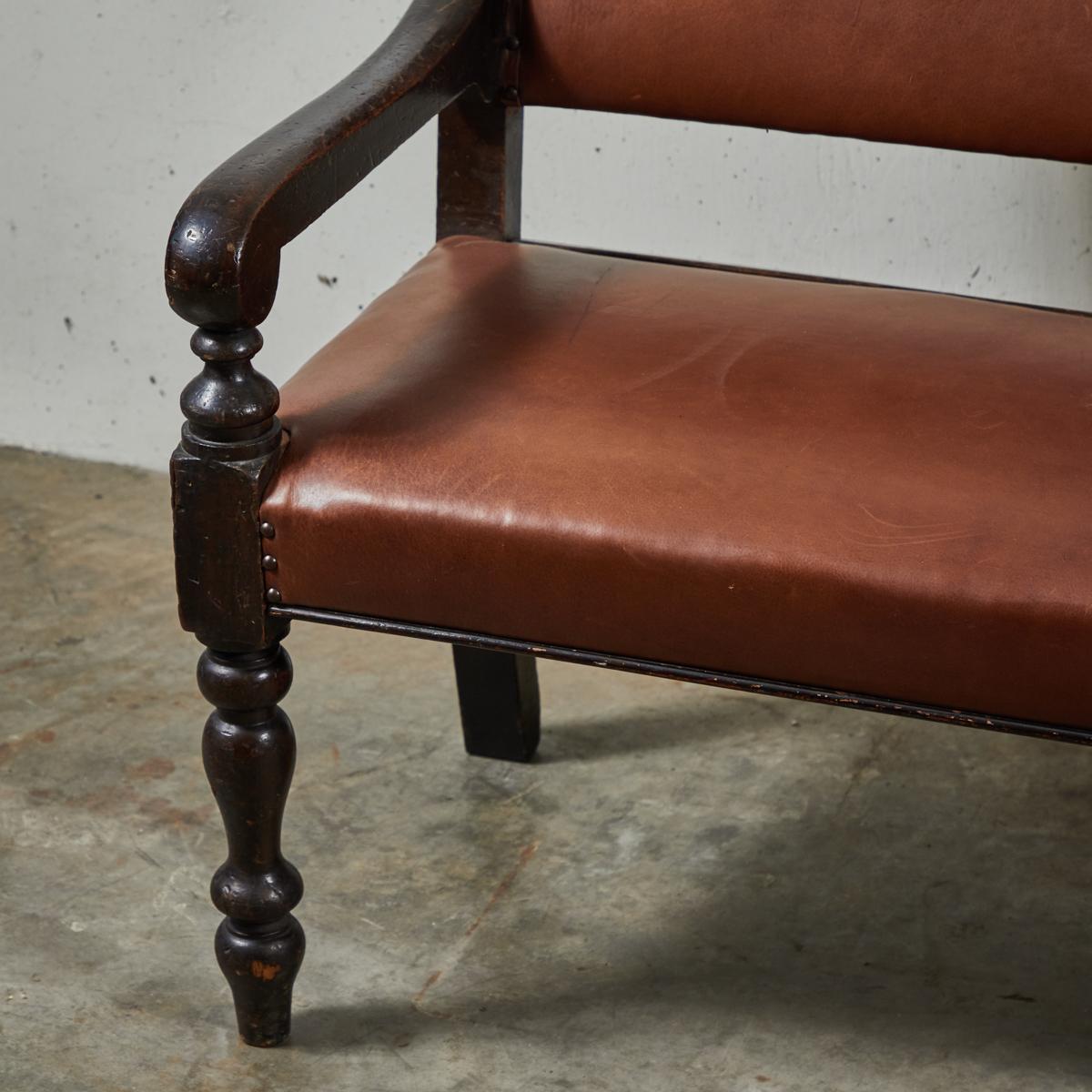 19th century English ebonized and upholstered leather bench from Masonic Lodge.