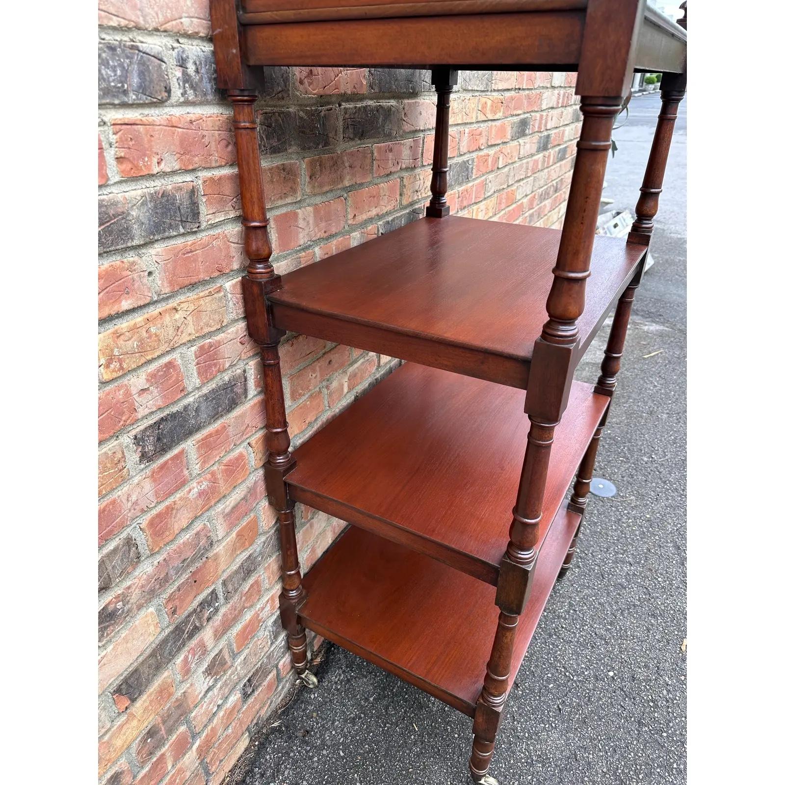 This is a beautiful mid 19th century English etagere with four shelves. Nicely turned legs resting on the original brass and white marble casters and beautiful patina and age. These are so useful and practical as well as being great aesthetic