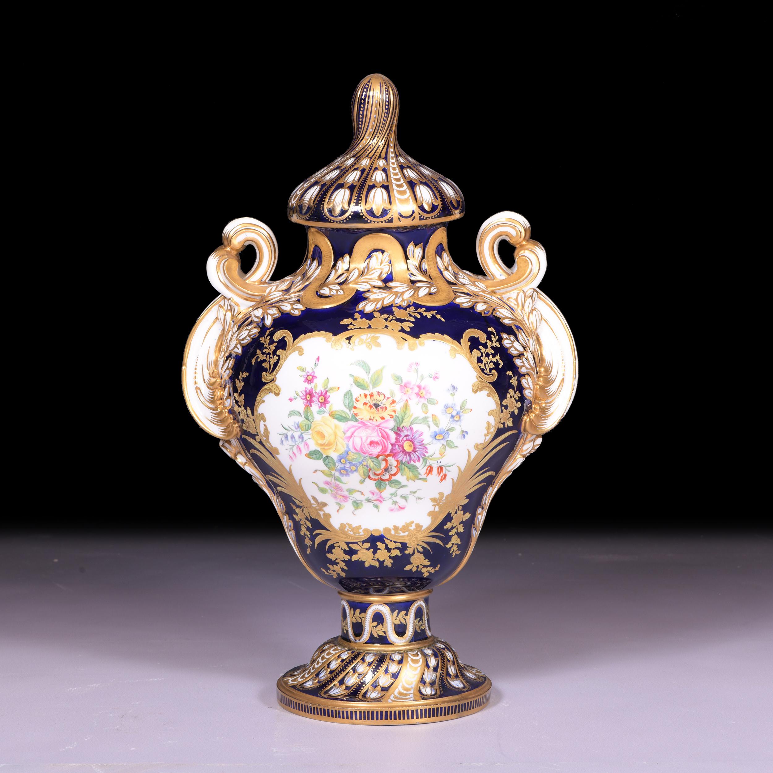 A magnificent mid 19th century twin handled centre vase by Minton. Painted with exotic birds and with blue, pink and gilt handles and borders. The type is known as Sneyd, number 301, from the design record books.

Exhibited In 1849 at The