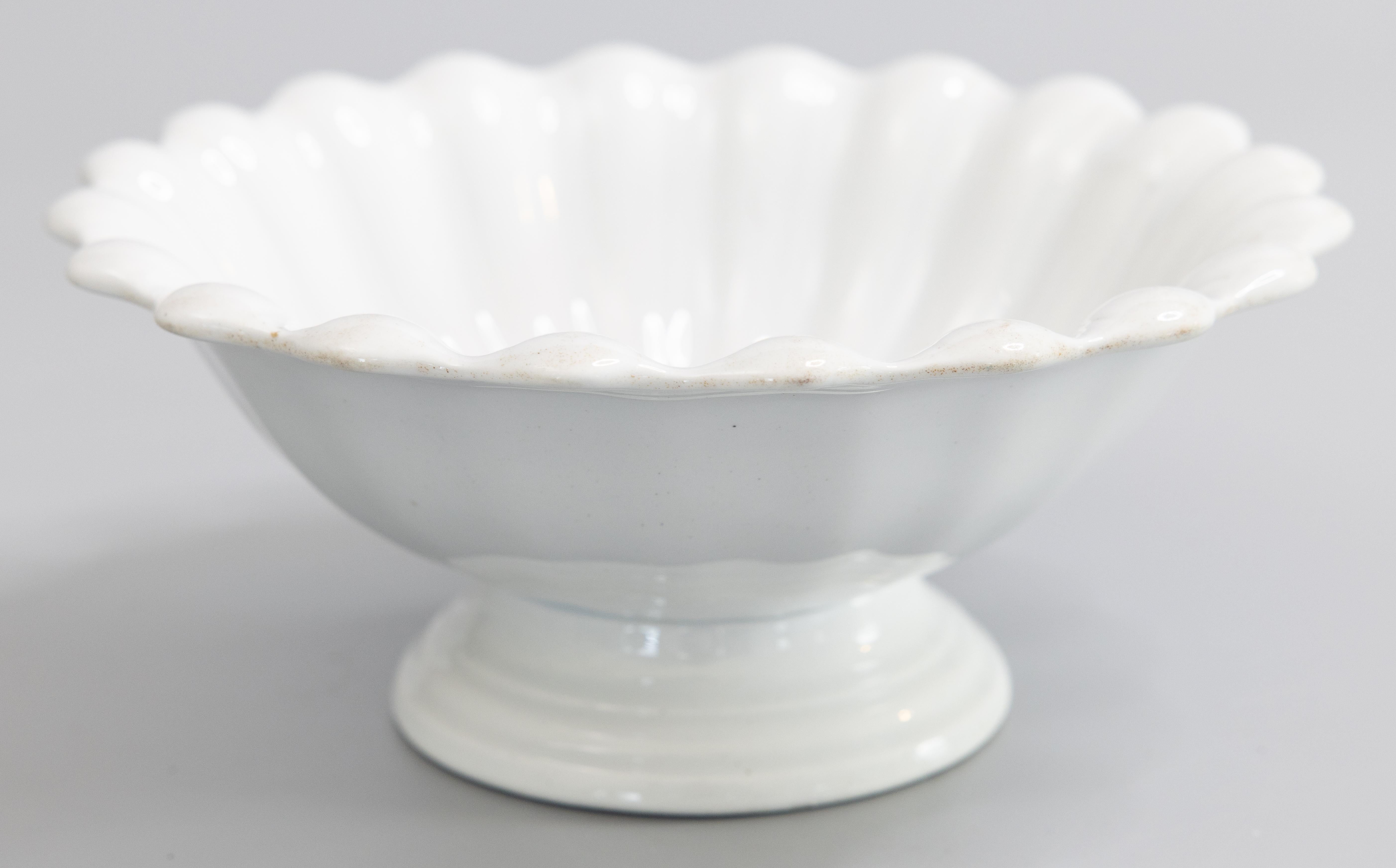A beautiful antique white ironstone footed bowl with a lovely fluted design by Bridgwood & Clarke, Stoke-on-Trent, England, circa 1860. Impressed maker's mark on reverse. This would be a wonderful addition to an ironstone collection and would look