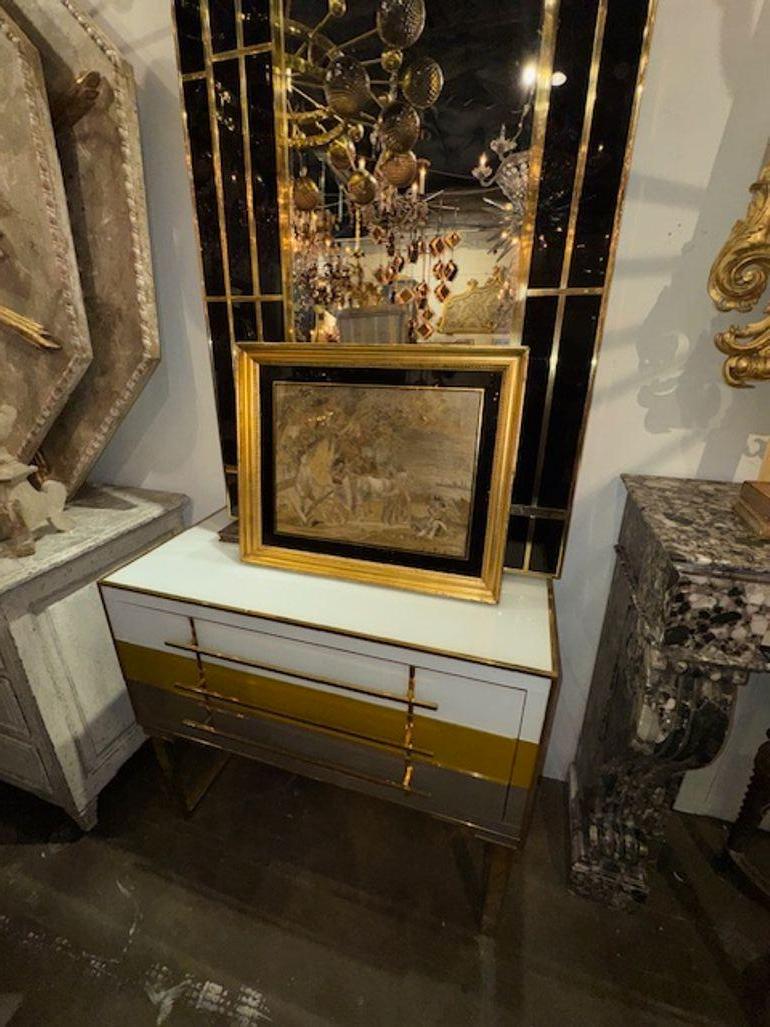 The 19th Century English Framed Silk Panel. The panel depicts a scene with horses and a wagon, showcasing intricate details and skilled craftsmanship. With a framed design, this piece is ready to be displayed as a unique and eye-catching addition to