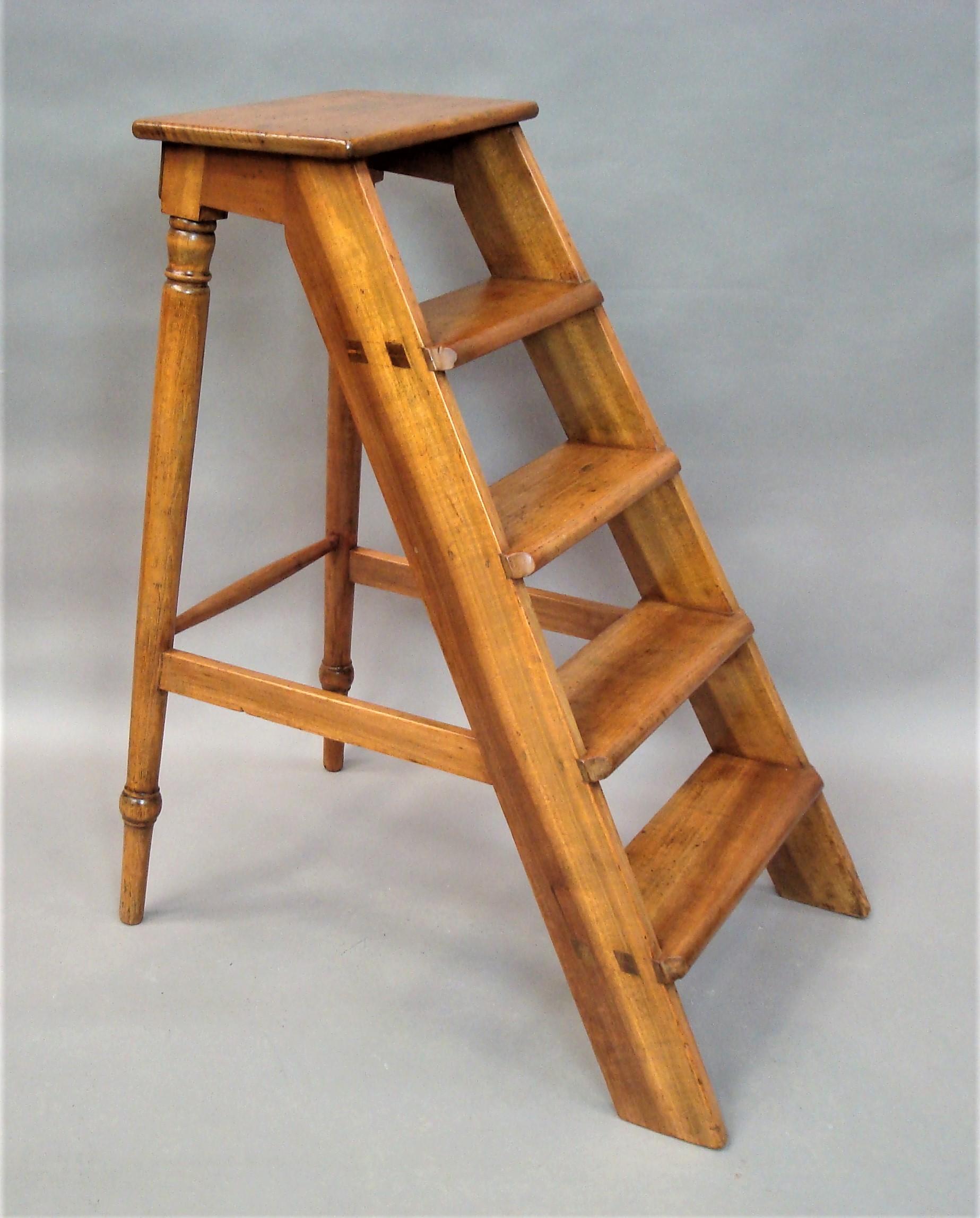 19th century English set of fruitwood library steps; the five treads of tapering form on a traditional 'A' frame with turned tapering legs to the rear, united by stretchers. Strong and sturdy, suitable for regular use. Good color and