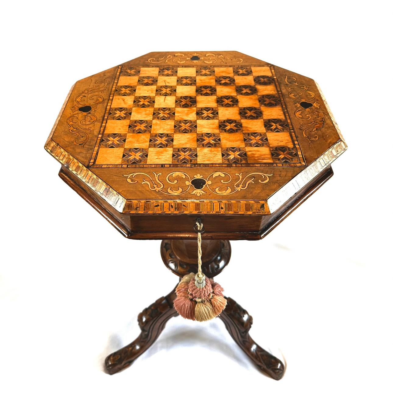 A superb quality, exquisitely handcrafted, English games/sewing table. Featuring delicate marquetry, banding inlay and intricate chequered cross banded inlay throughout.
Lift the lid to reveal a sewing box with original fitted interior comprising