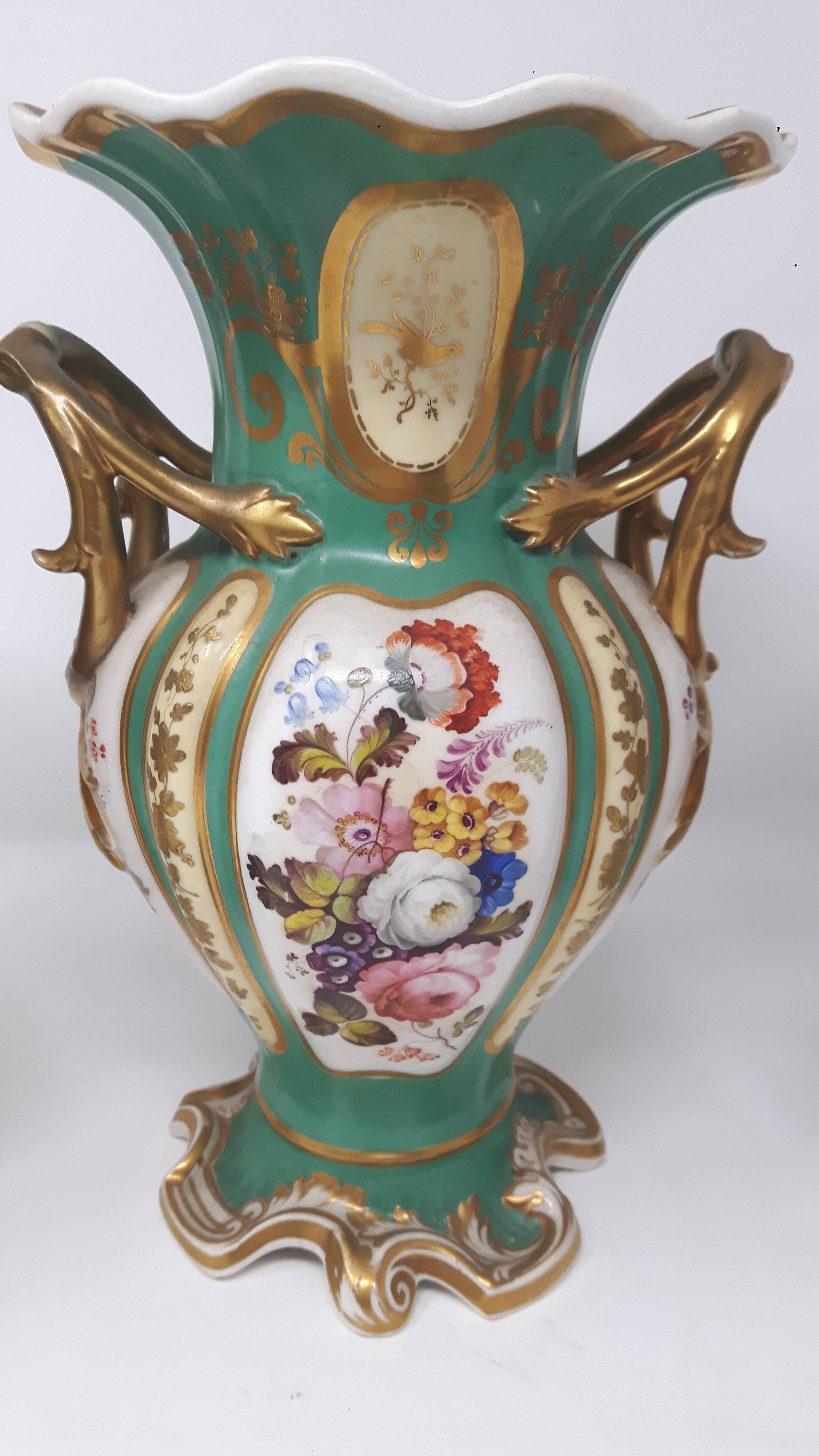 A garniture of three Coalport vases, each finely painted with scenes of bouquet of flowers, on apple green and gilt background.
