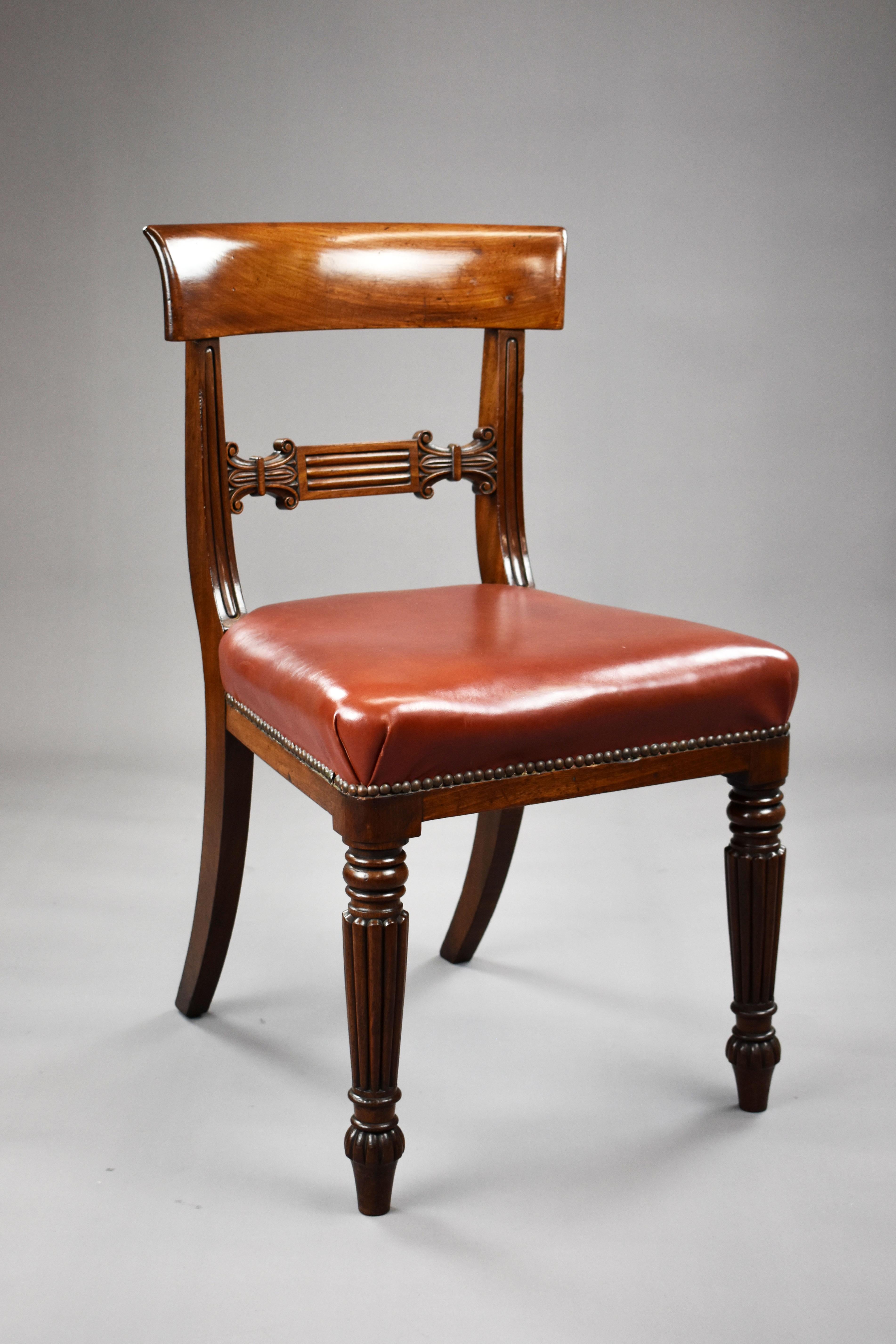 A good quality set of 4 George III mahogany dining chairs, having bar backs over red faux leather seats, standing on turned and reeded legs. All of the chairs are structurally sound and all remain in very good condition for their age.