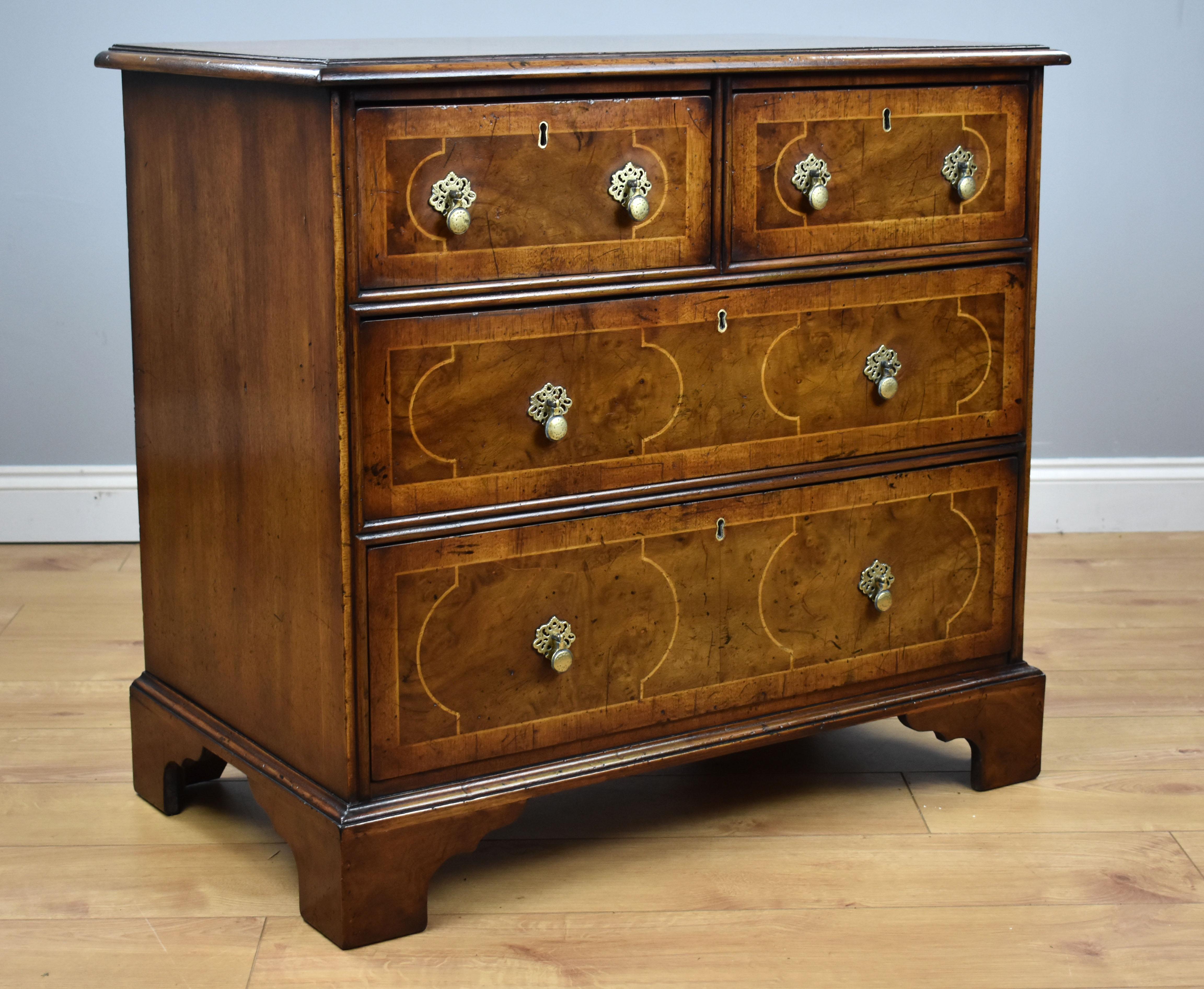 For sale is a good quality 19th century burr walnut chest of drawers. The top has a walnut banded edge, decorated with white line inlay, above an arrangement of four drawers (two short over two long) each with brass handles and further white line