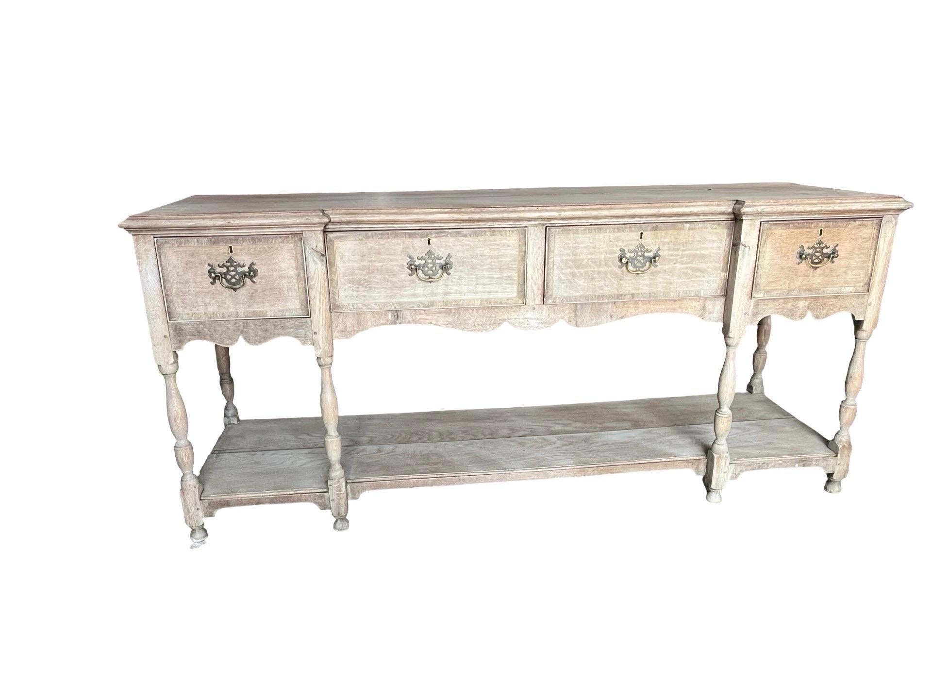 Georgian dresser base hand-crafted in the UK in the early 1800s using oak. The base has been bleached, bringing out the beautiful grain of the wood and providing it with depth and a very modern look. The plate dresser base follows the typical style