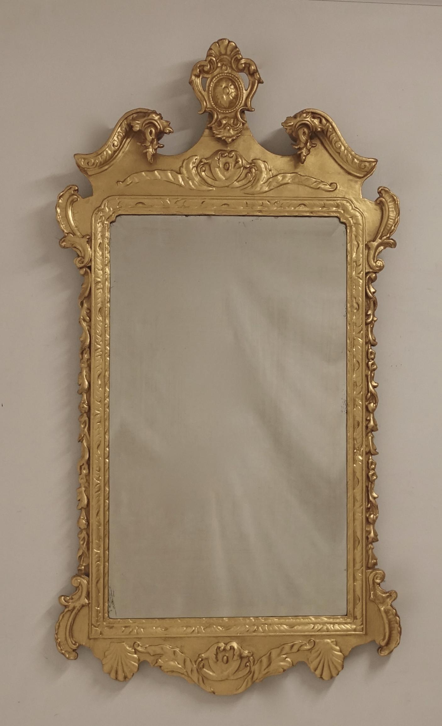 Mid-19th century English gilt wood wall or over mantle mirror in the Georgian style with original mirror plate.
Gilding refreshed in the 20th century.
In very good antique condition.