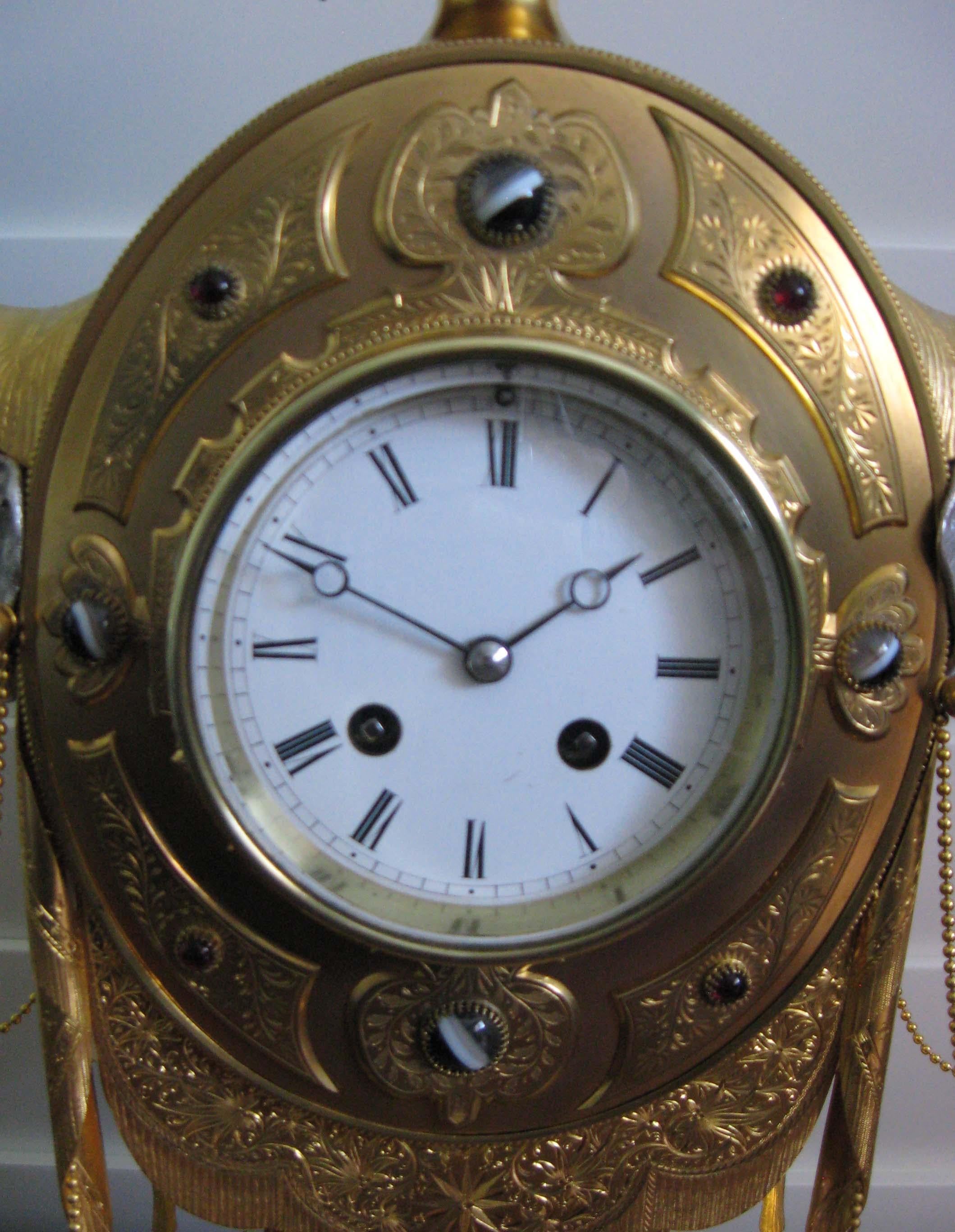 A beautiful English hard stone gilt bronze and silvered mantel clock, late 19th century, attributed to Howell James, the design by E Finley, circa 1871. Possibly made for the Turkish market.
  
The clock surmounted by a minaret with moon crescent