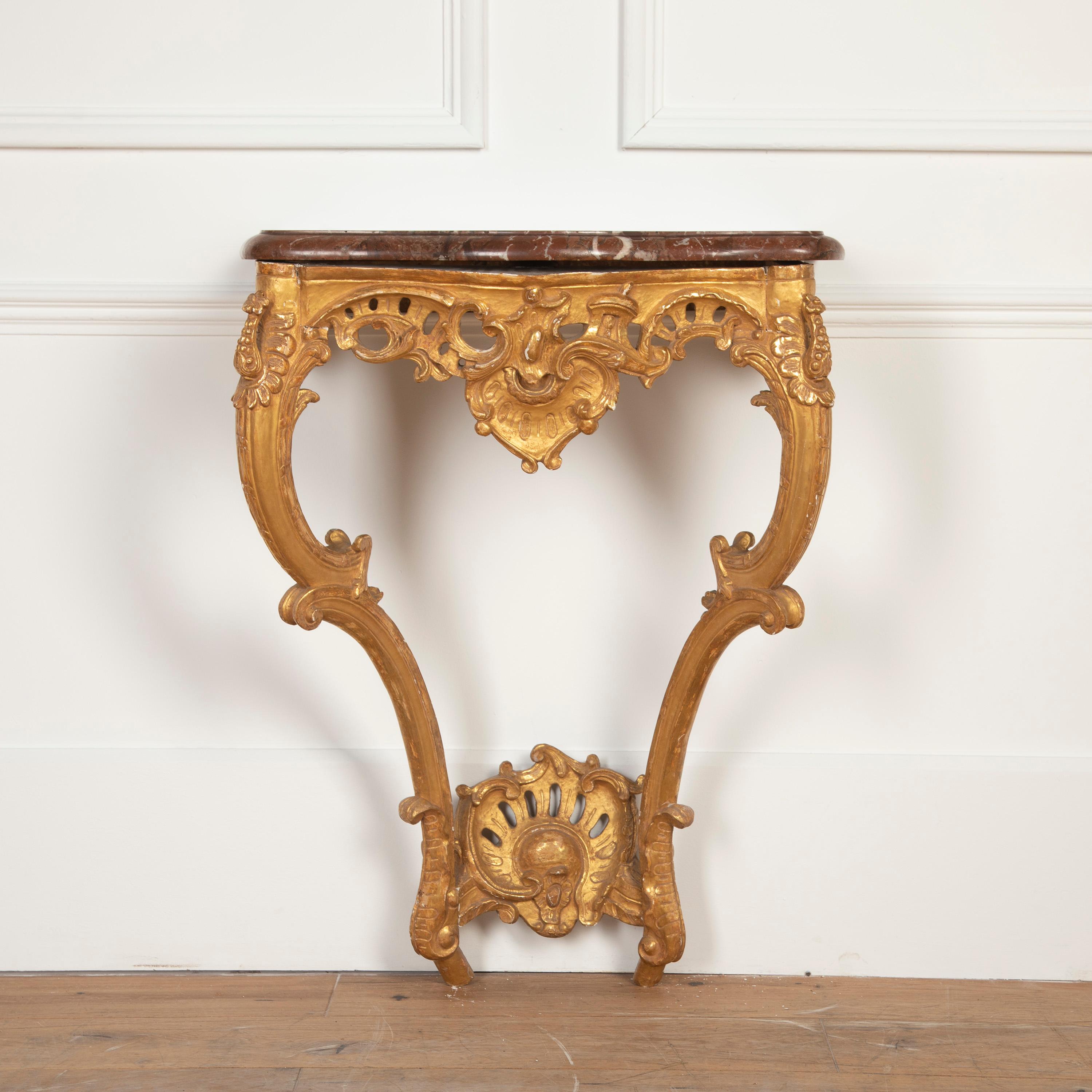 Superb early 19th century English gilt console table. 

This charming piece is of elegant proportions and features hand-carved detailing throughout the wooden structure. Sitting above the wooden structure is a large piece of marble that is