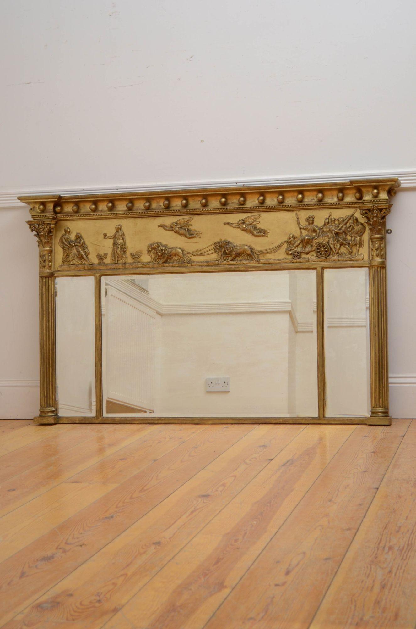 Sn5394 A large gilded over mantel mirror, having three original bevelled edge mirrors, in giltwood frame with cavetto cornice and Neoclassical scene to frieze all flanked by reeded columns with finely carved capitals. This antique mirror retains its