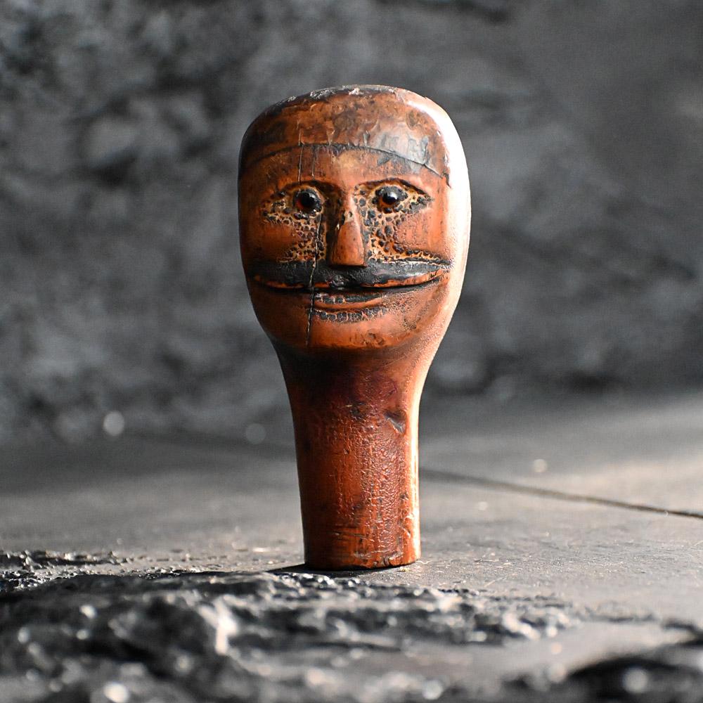 19th Century English Glass Eyes Puppet head 
A deeply patinated fruit wood late 19th Century glass eyed puppet head. With aged paint surface and remanence of old paper across the top of its head. A great looking moustache in our humble opinion.