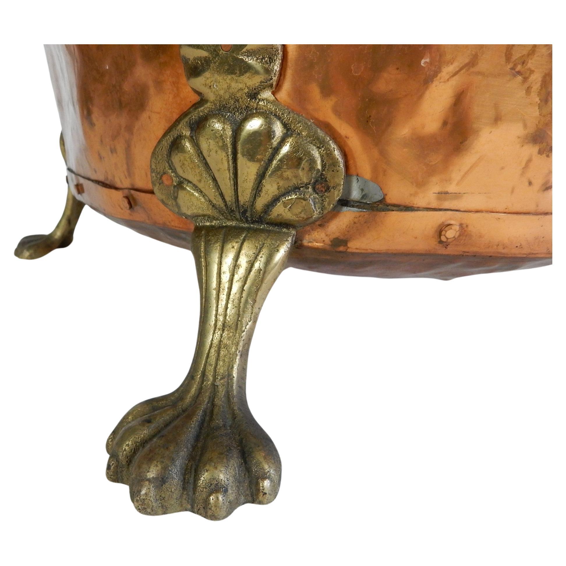 Classic Baroque Revival hammered copper log bin, planter or wine cooler with large claw feet and lion medallion handles.
Well used but still retains all parts and a lovely aged patina.
Large piece measuring 15