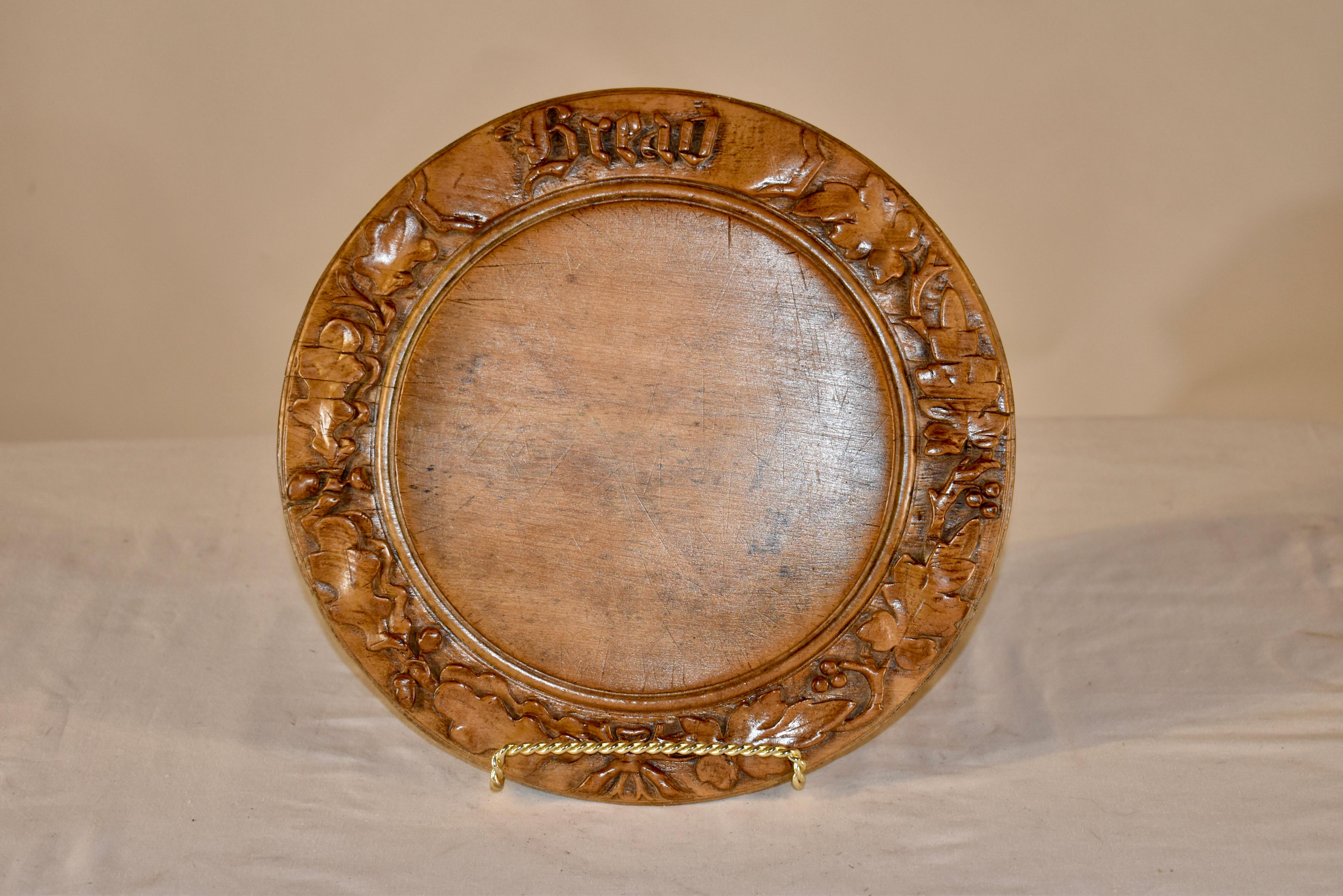 19th century English bread board made from sycamore.  the border is hand carved with the word bread and a hand-carved design of oak leaves and acorns, which were a sign of wealth and welcome. these boards look wonderful on a dining table or island,