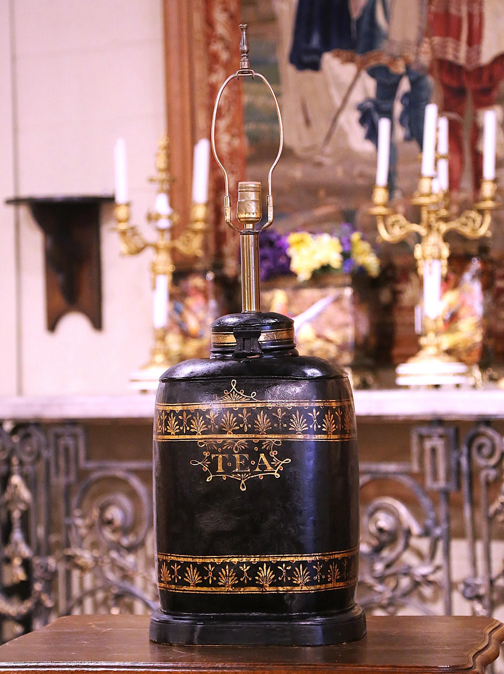 Decorate a bedside table, or a side table in a living room with this elegant antique canister lamp. Created in England, circa 1890 and made of tole, the large tea box features the word 
