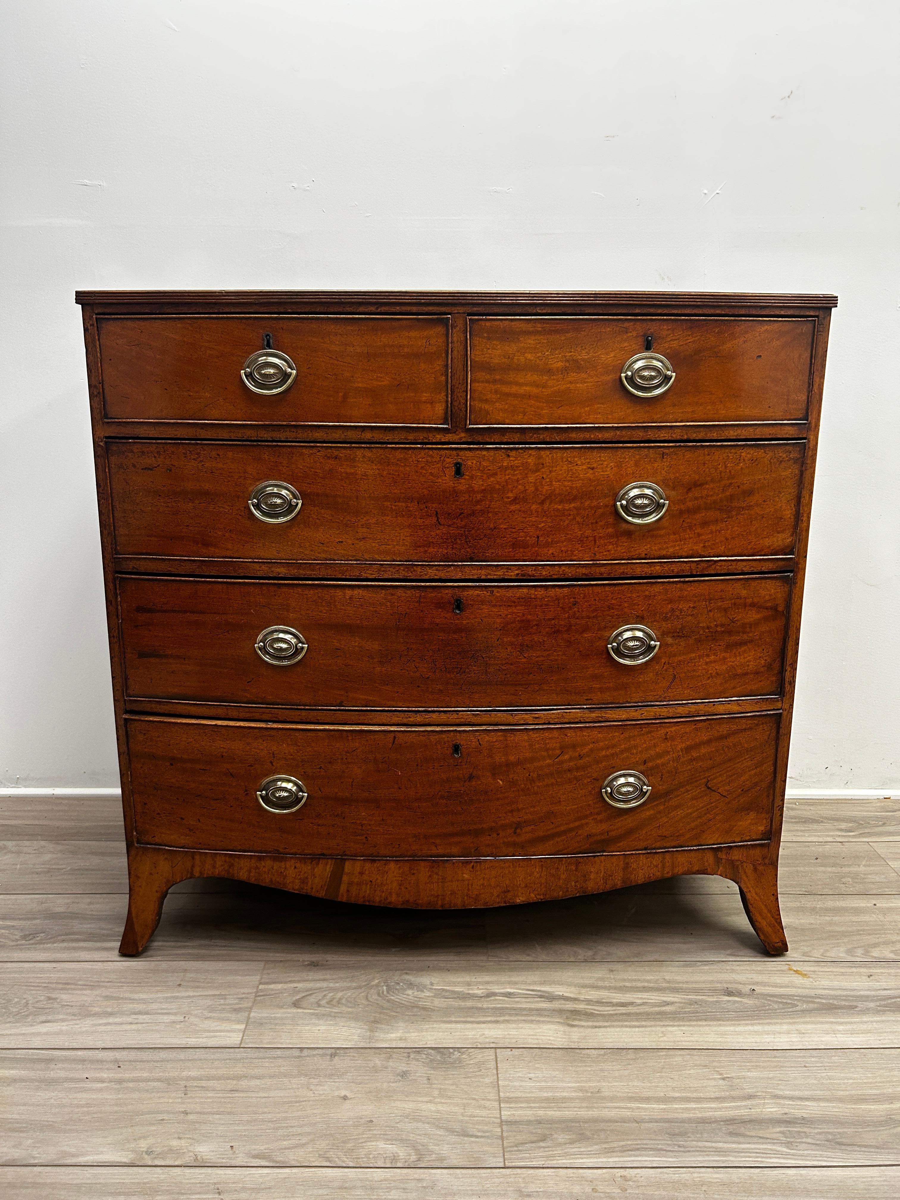 Introducing an exquisite piece of furniture that will add both elegance and functionality to any room - a 19th century English Hepplewhite style bow front chest of drawers. This stunning chest is a true testament to the skilled craftsmanship of the