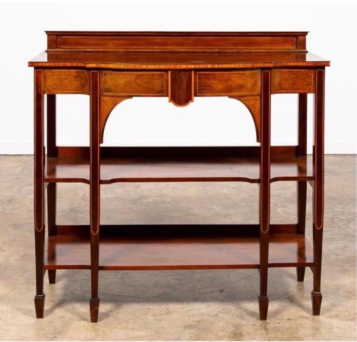 Tiered mahogany server or buffet in the Hepplewhite taste having an inlaid case, two shelves and rising on tapered legs with spade feet.