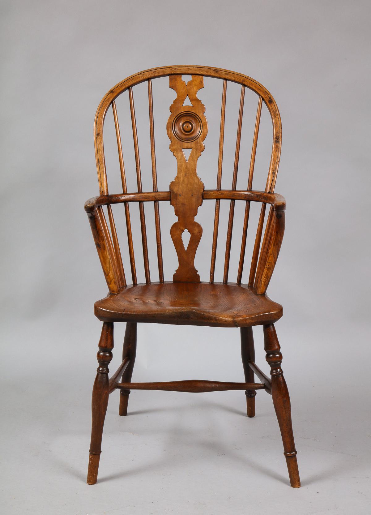Good 19th century English hoop back Windsor armchair with roundel turned back splat, over shaped seat and standing on turned legs joined by 