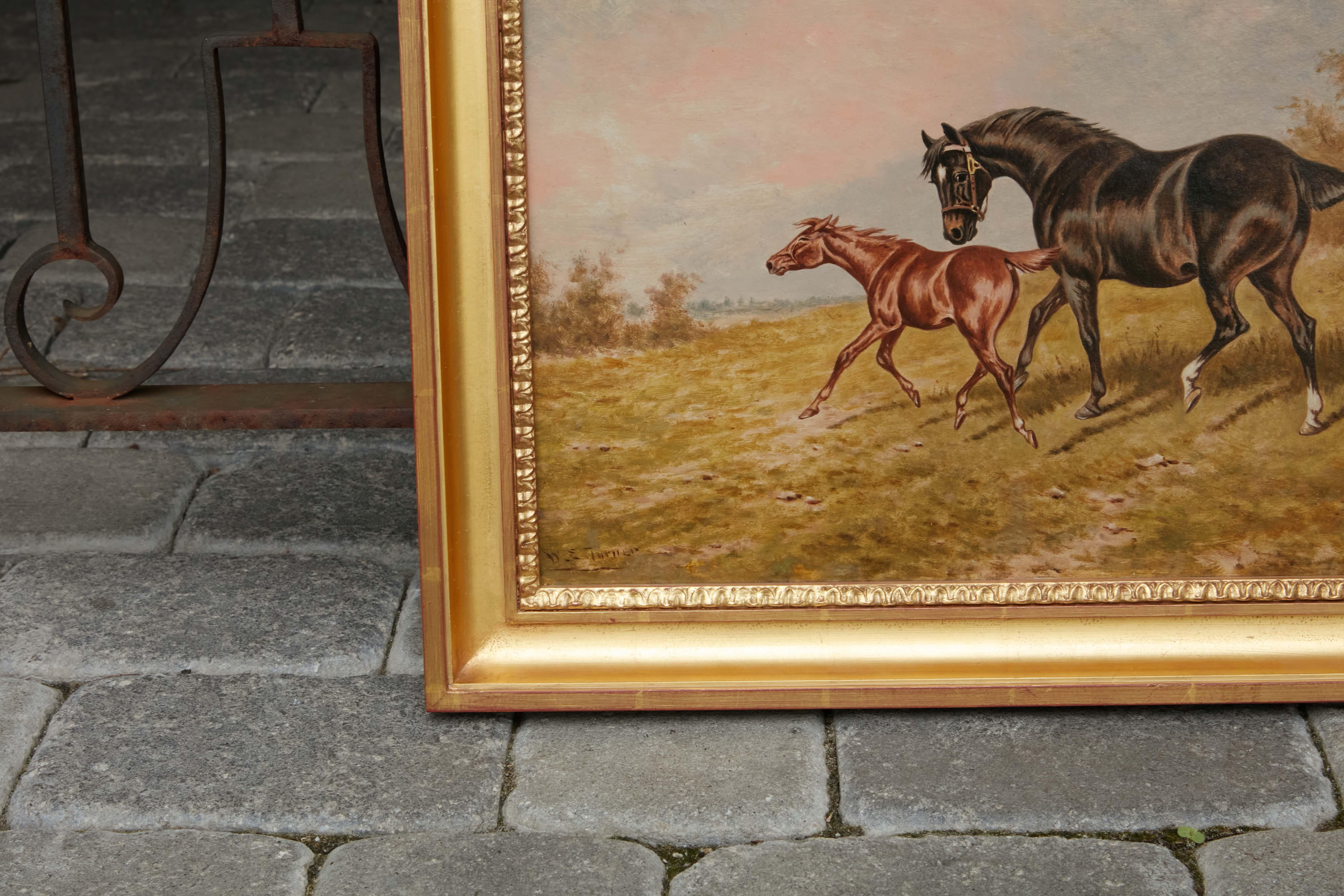 An English oil on board horse painting from the 19th century signed by N. E Turner, depicting a mare and foal in gilded frame. This English oil on board painting from the 19th century, signed by N. E. Turner, depicts a graceful scene of a mare and