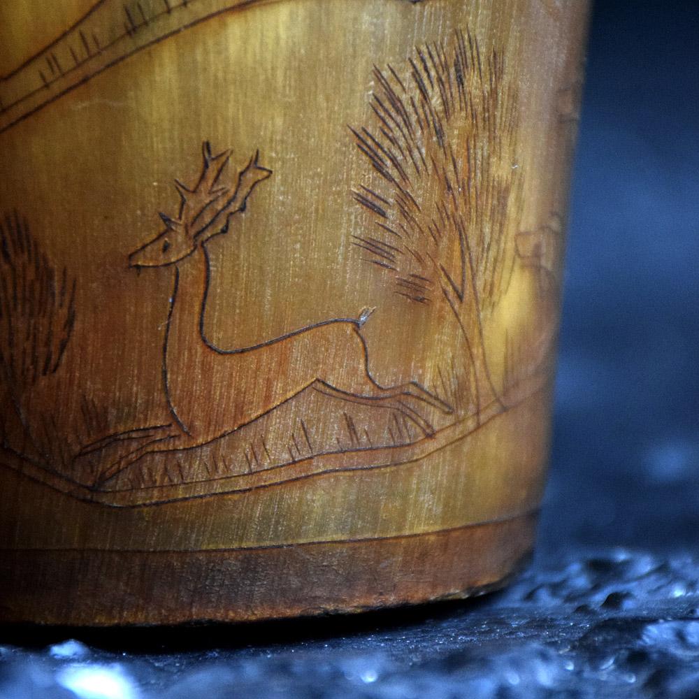 19th century English hunting scene Scrimshaw beaker 

We are proud to offer a very exquisitely decorated mid-19th century English scrimshaw horn beaker. Depicting a fox hunting scene traveling through a country landscape, with various houses and