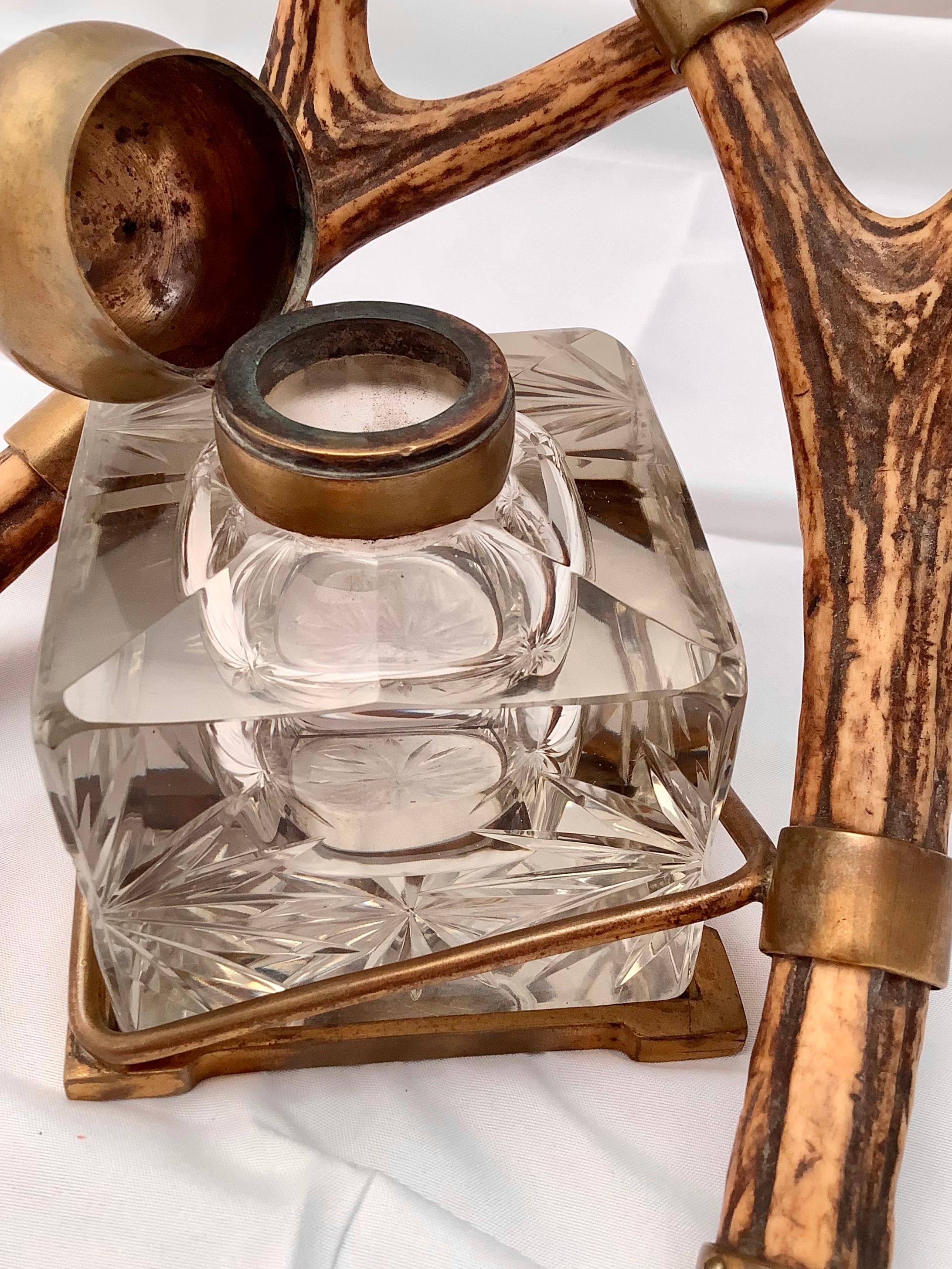 Beautiful and unique inkwell. Cut crystal inkwell with brass top cradled by two antlers.