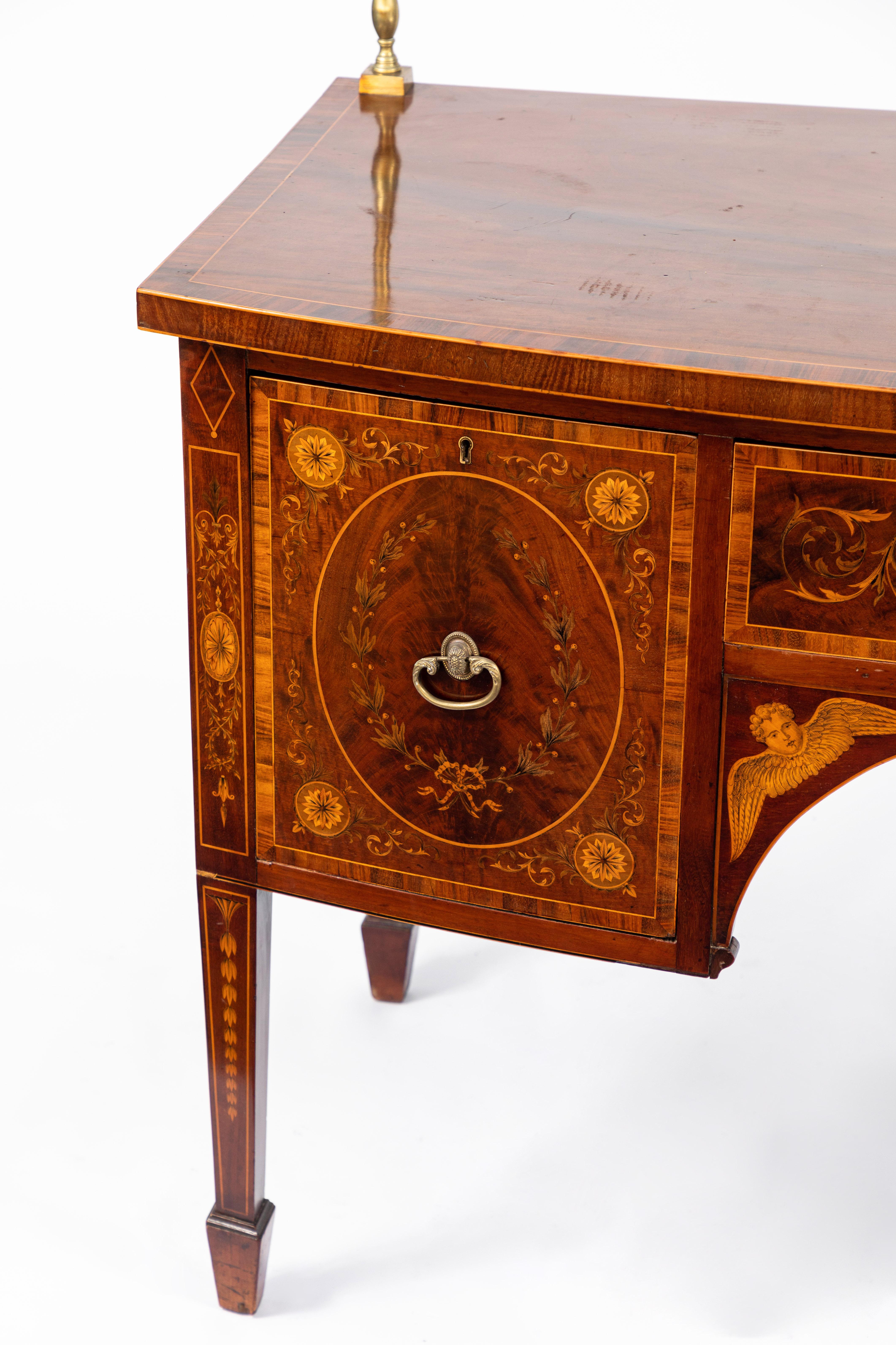 19th century English inlaid sideboard with very fine details of cherubs, rosettes etc. Original brass. Mahogany with satinwood inlay. Signed by the maker, London.