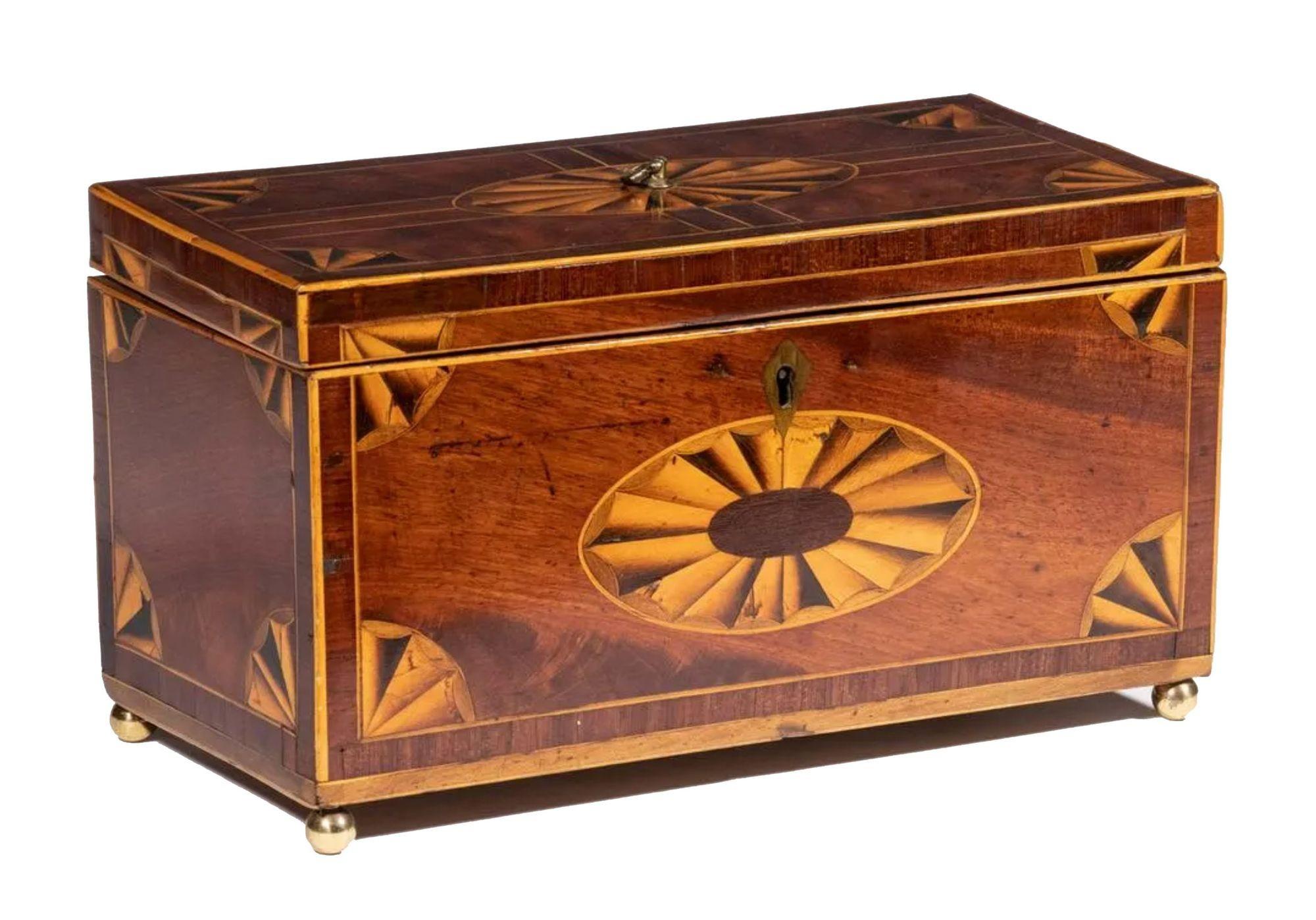 A 19th century English mahogany triple compartment tea caddy. The lid and front panels have an oval fan paterae and corner fan inlays. The interior has three lidded compartments, each lid with an oval floral decorated inlaid panel.
 
Dimensions: 5