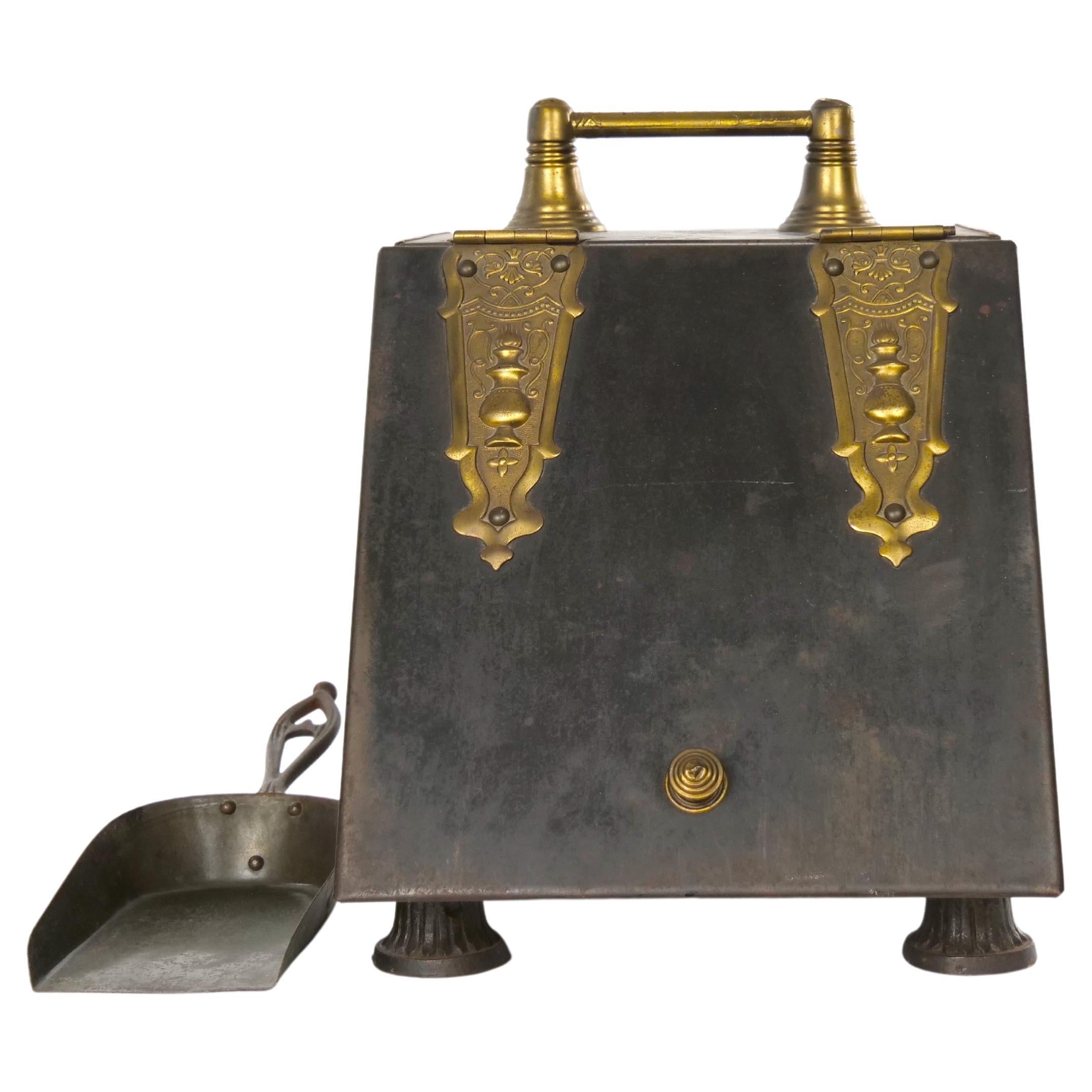 Antique Victorian beautiful brass / Iron footed fireplace coal bucket scuttle. The bucket features an embossed lift up lid opening to reveal a storage compartment for coal, beautiful ornate brass carrying handle with a brass shovel and raised on