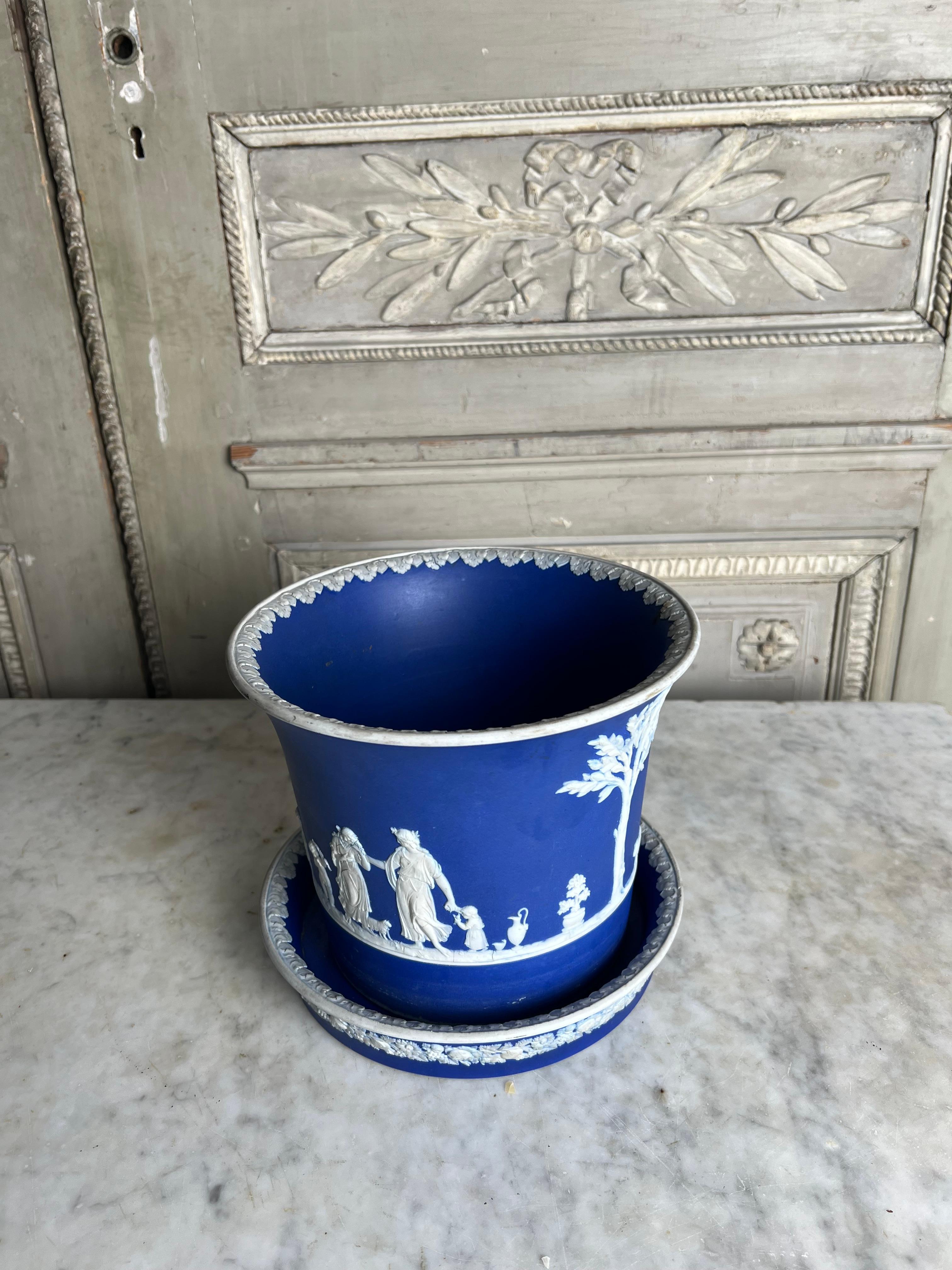 A 19th century English Jasperware planter and underplate, stand in a dark blue and white glaze in the neoclassical style.  This decorative and useful cashepot jardiniere is rare that is still has it's stand or under plate.  