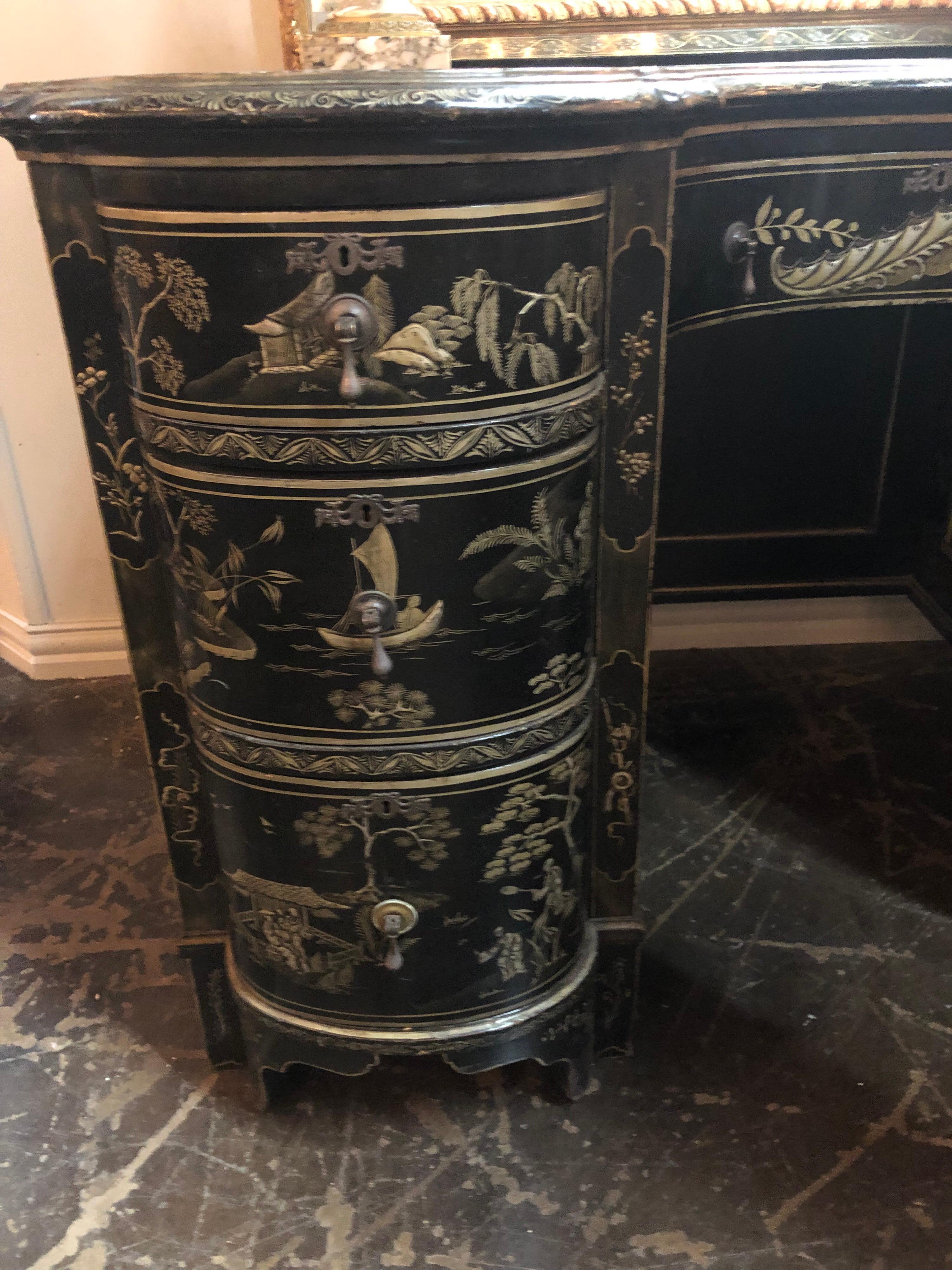 Phenomenal 19th century English kidney-shaped writing desk with inset leather top. The single centre drawer flanked by a column of three drawers on each side.

Decorated overall with remarkable chinoiserie Asian landscape and river scenes