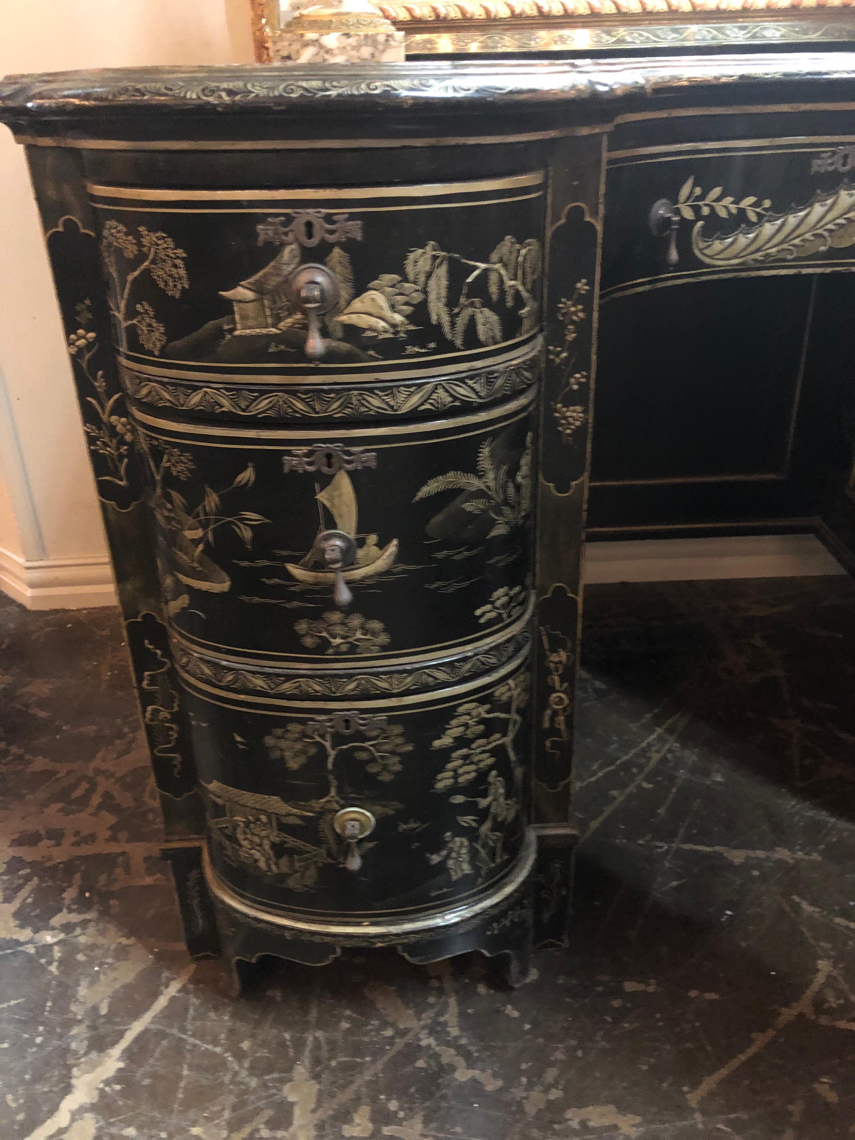 Phenomenal 19th century English kidney-shaped writing desk with inset leather top. The single centre drawer flanked by a column of three drawers on each side.

Decorated overall with remarkable chinoiserie Asian landscape and river scenes