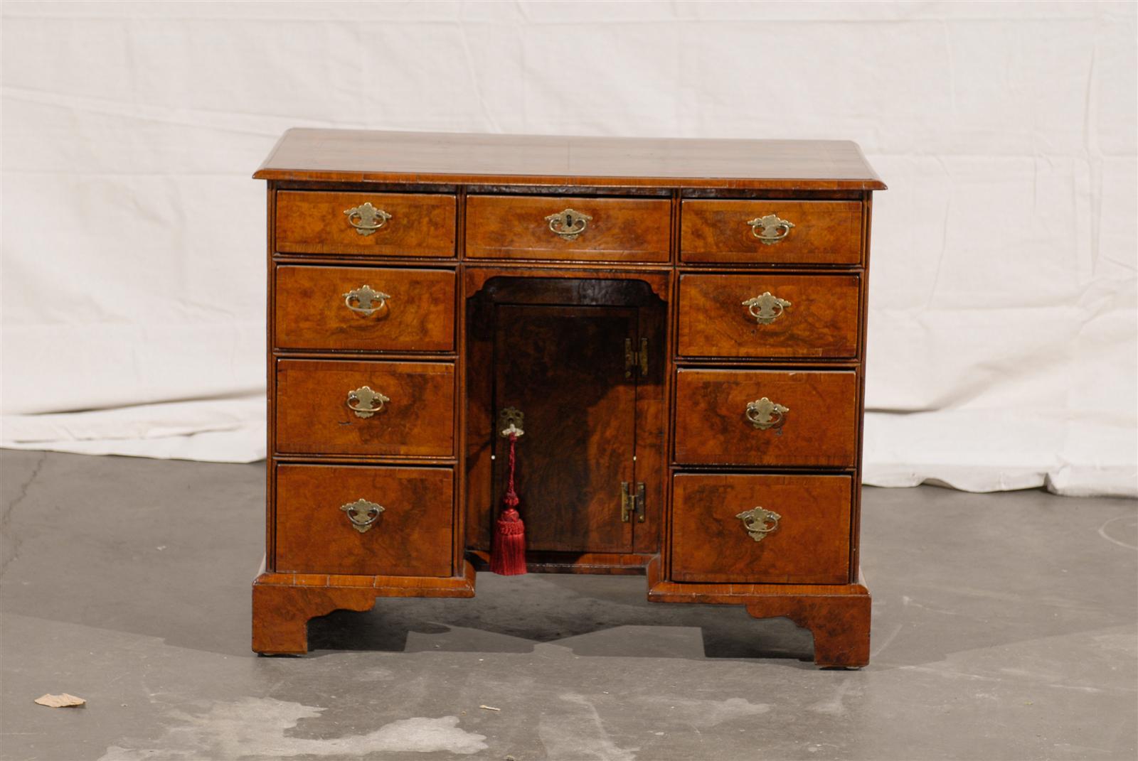 19th century English knee hole desk with burled walnut top.