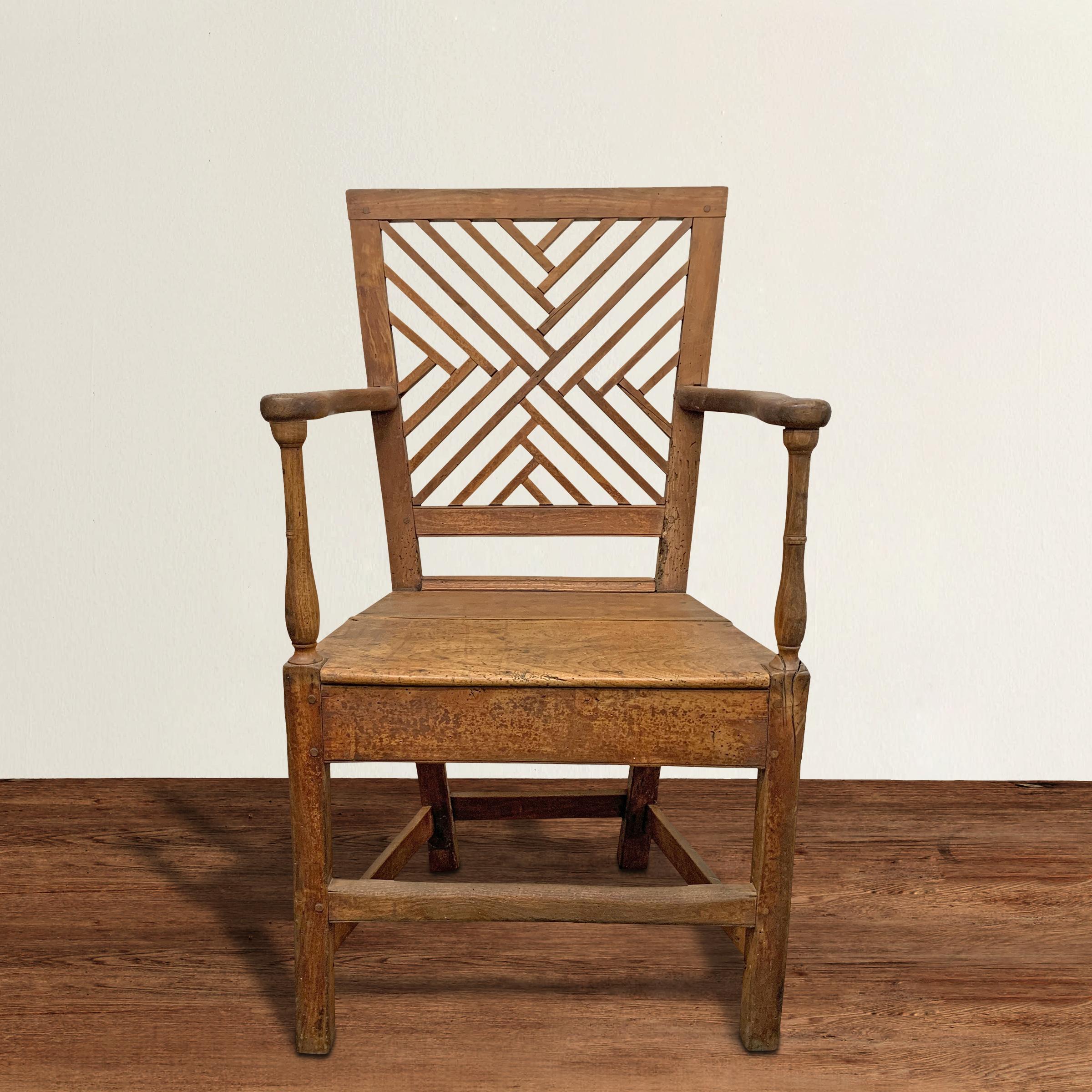 A striking 19th century English elmwood armchair with a fantastic lattice-back, out turned arms with turned supports, with all parts being of pegged construction. This would be so charming with a new cushion!
