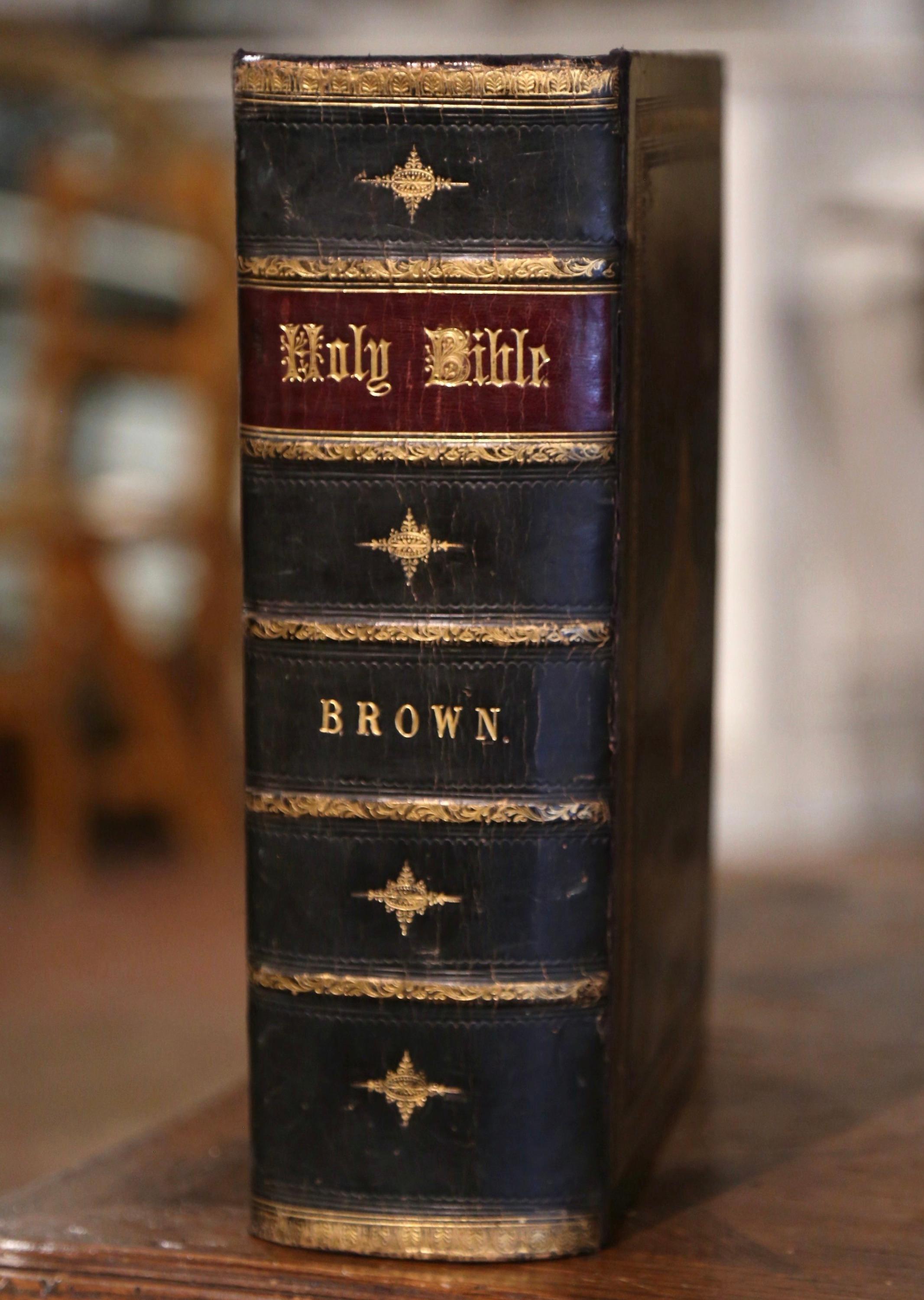 This beautiful antique Holy Bible was printed in the United Kingdom by Blackie and Son dated 1864. Black leather bound, the bible flaunts an engraved and embossed gilt covering with a center medallion, and the spine is engraved with 