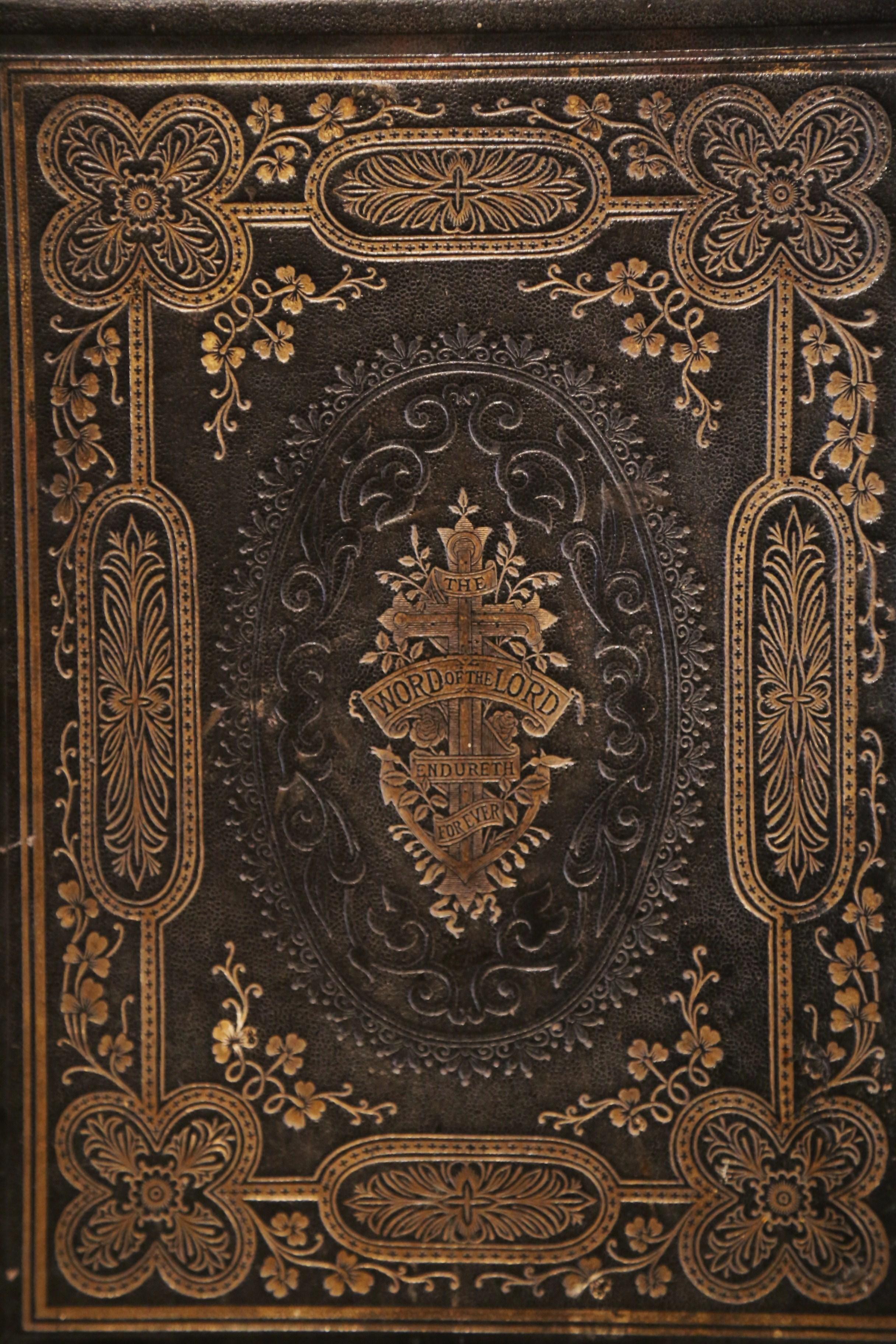 This beautiful antique family bible by Rev. John Brown was printed by Dunn & Wright, Glasgow, circa 1880. The book flaunts an engraved brown leather and gilt covering, and is embellished with two brass locks and embossed brass edges. Inside, the