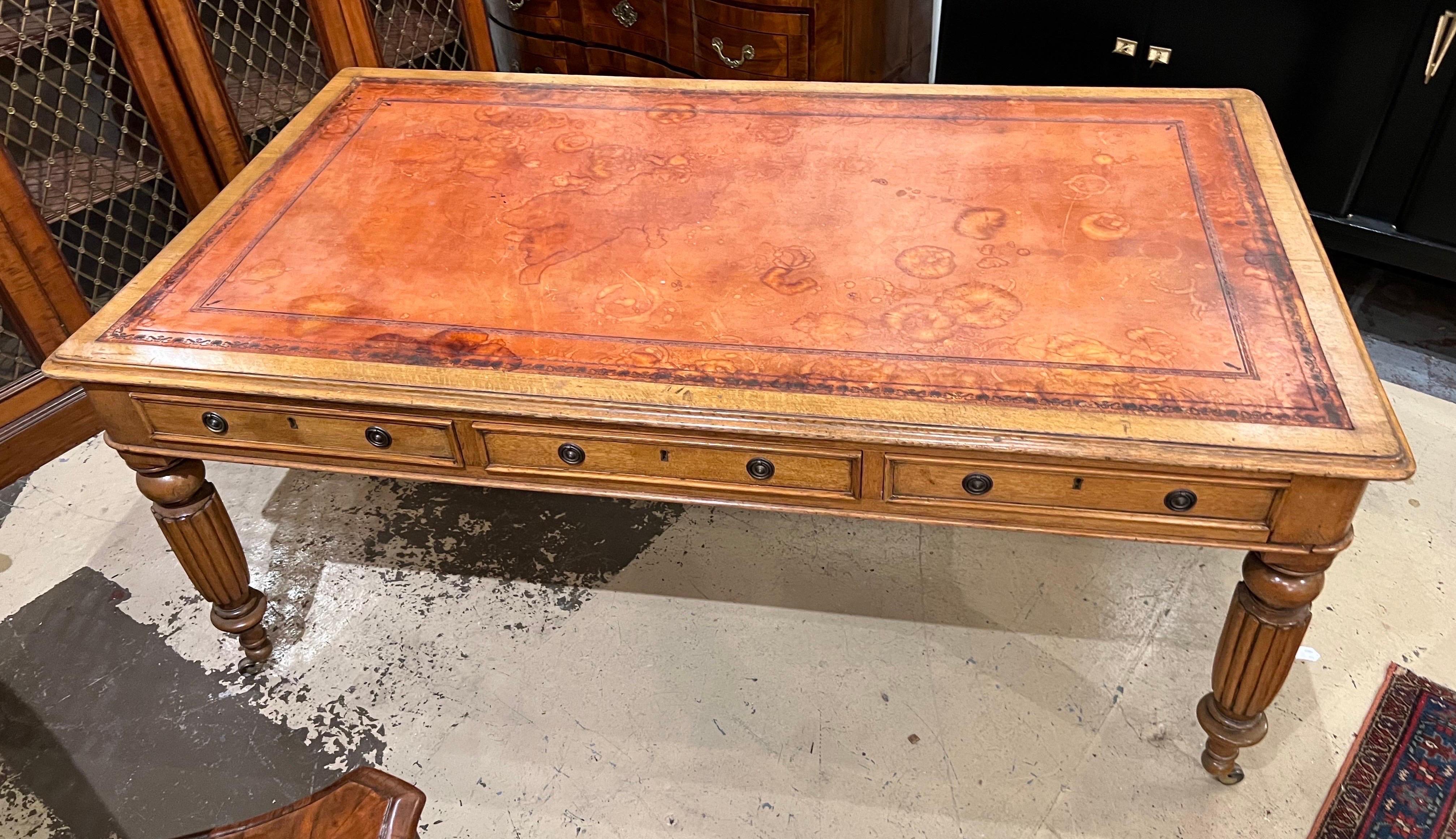 19th century English leather top oak writing table on castors with 3 drawers on both sides. 24” clearance from floor to apron. Wonderful patina to leather from years of use.