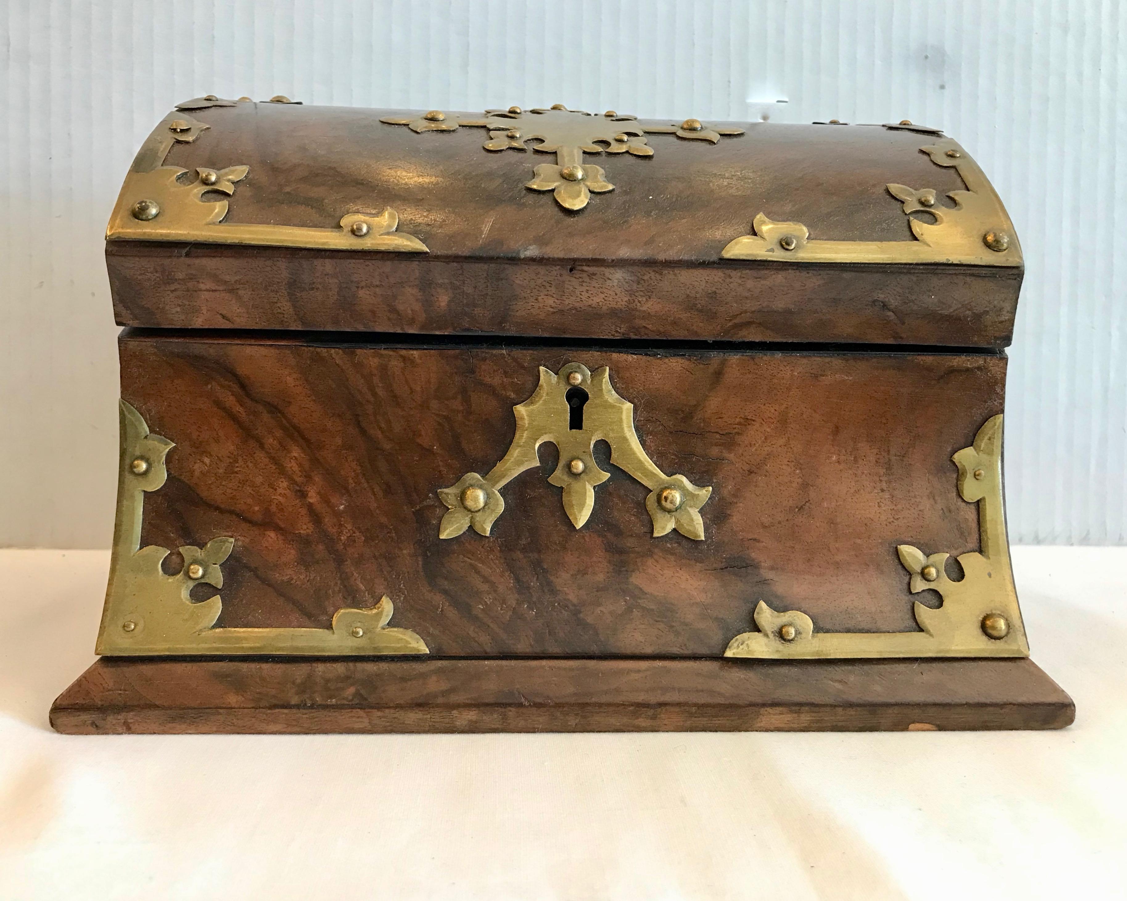 Superb quality with elaborate brass applied accents.
It is fashioned with burl walnut veneers and the interior is fitted slots for mail.