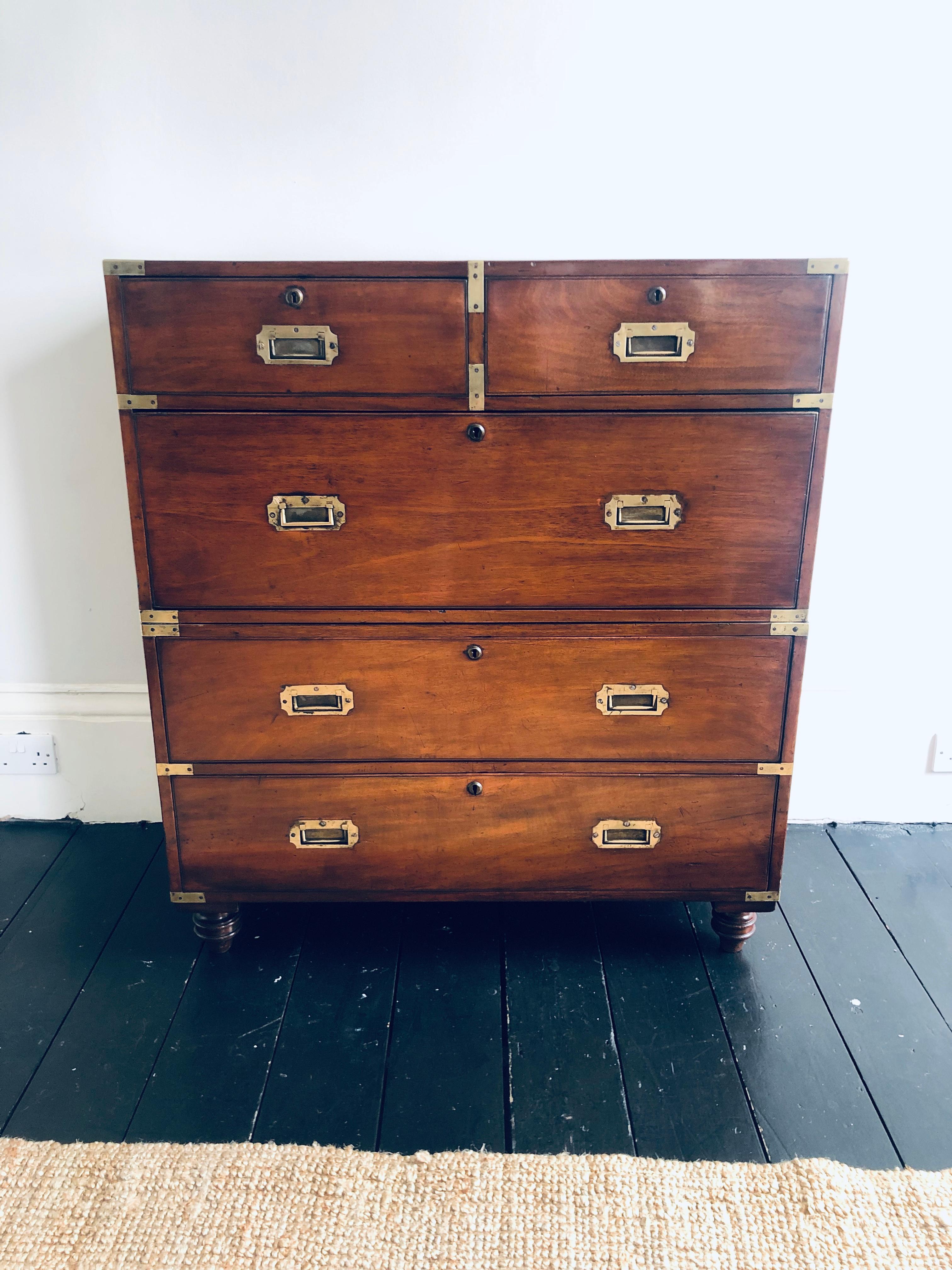 A 19 century English mahogany and brass bound campaign chest in two sections with turned supports
With solid mahogany drawer fronts and ash linings and original brass work throughout. The turned supports are later but 19th century.
 