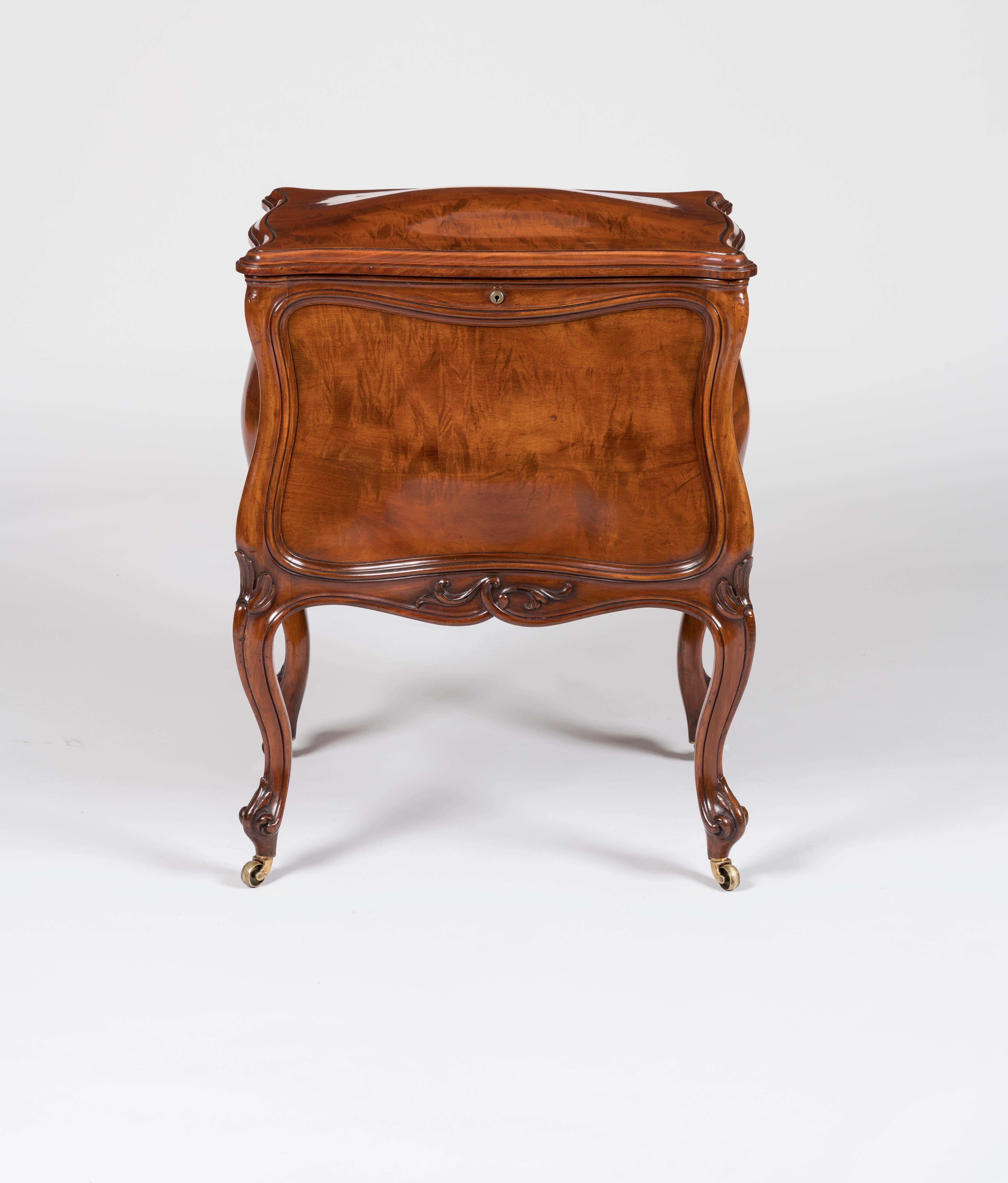 A wine cooler by Holland & Sons
 
Constructed in mahogany, rising from swept cabriole legs with castors; the bombe and serpentine form body having a lockable cover, with a Bramah lock, marked '124 Piccadilly', enclosing a removable silver plated