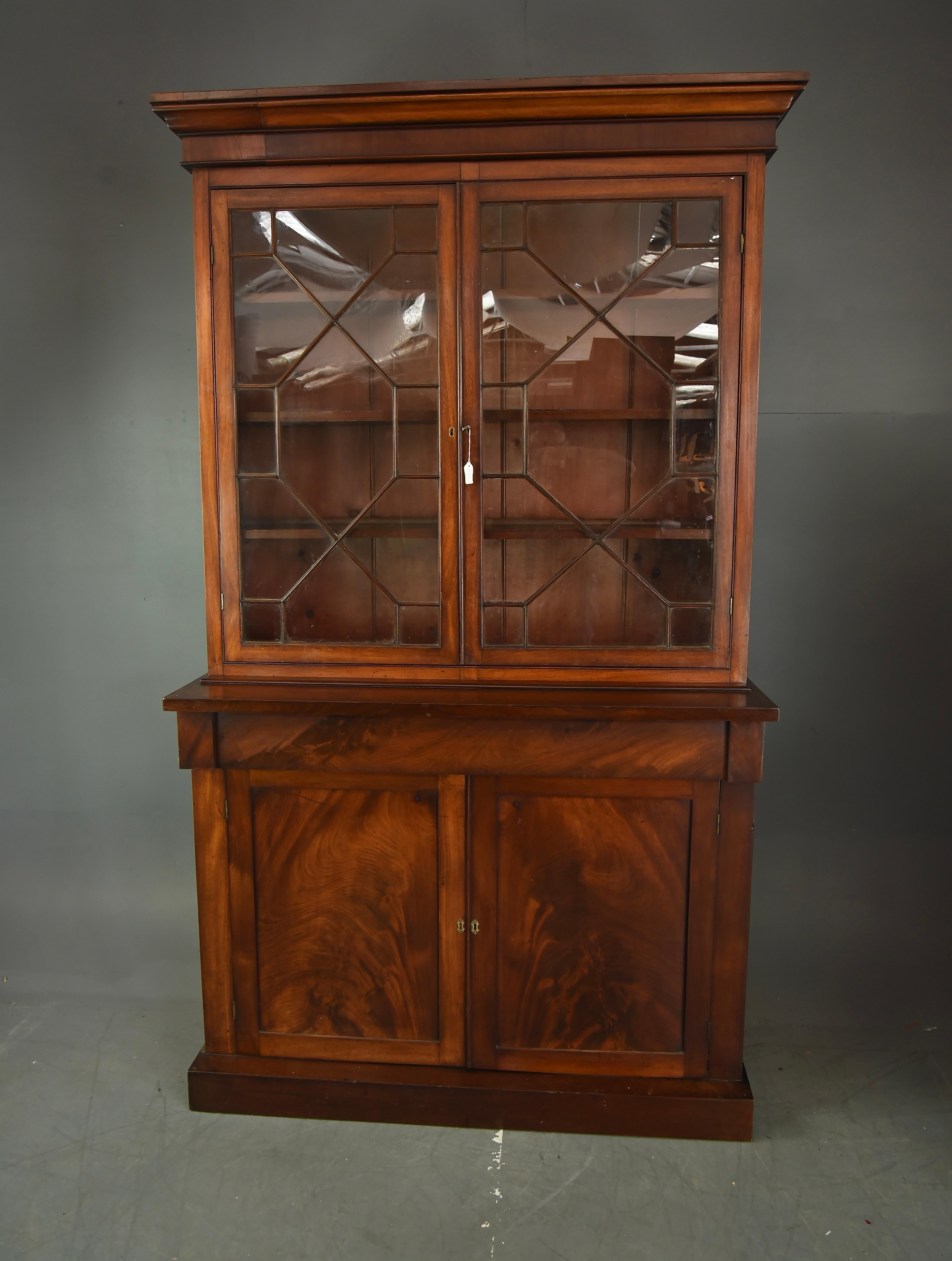 Good early Victorian mahogany two door bookcase circa 1840 
The bookcase has three fixed shelves behind two glazed doors ,the internal depth is 23.5 cm  ,with a cupboard below with a single fixed shelf .
The bookcase is in very good condition with a