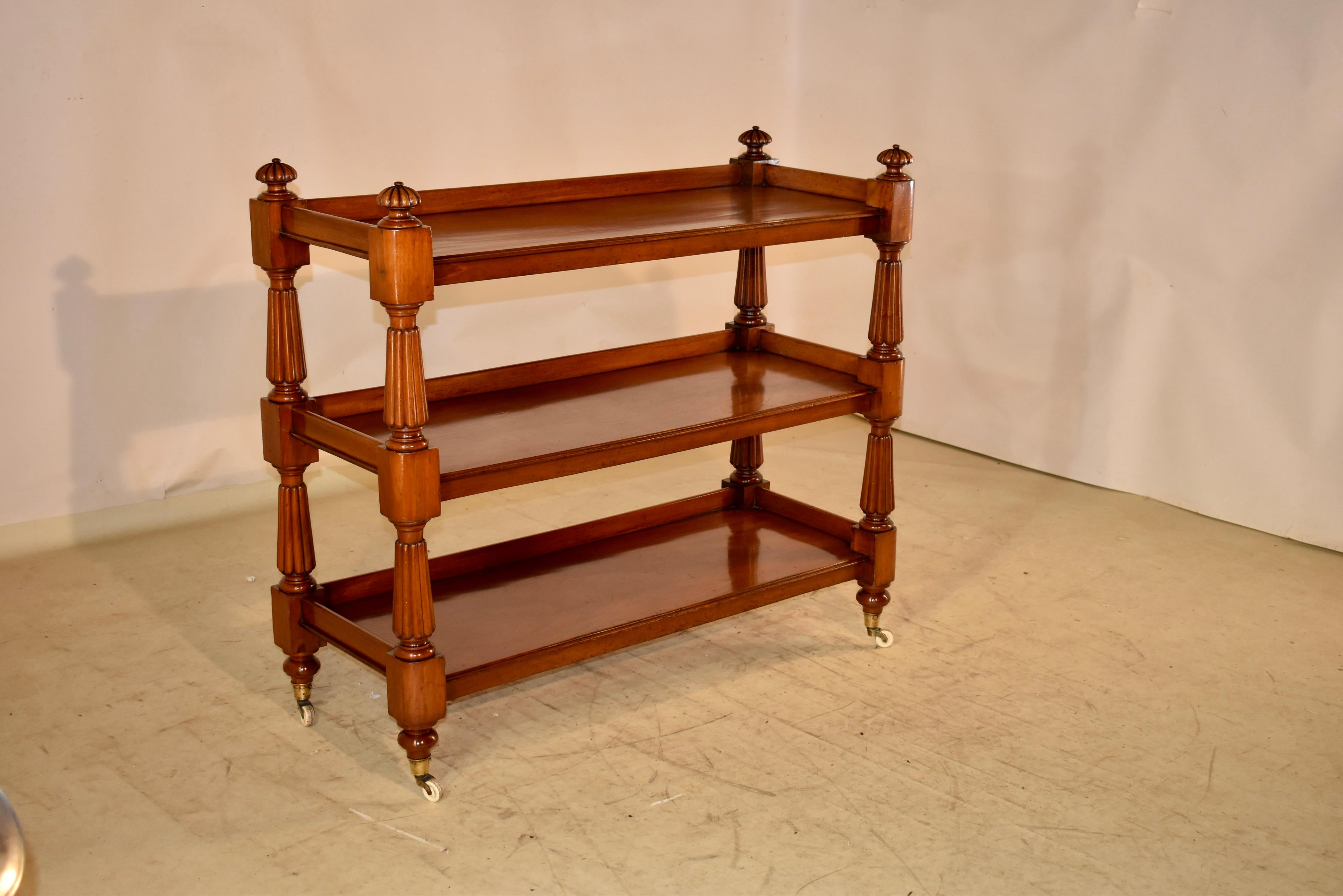 19th century mahogany buffet from England.  The top is decorated with turned and reeded finials over galleried shelves.  There are three shelves, all made from single wide planks of gloriously grained mahogany.  The shelves are separated by hand