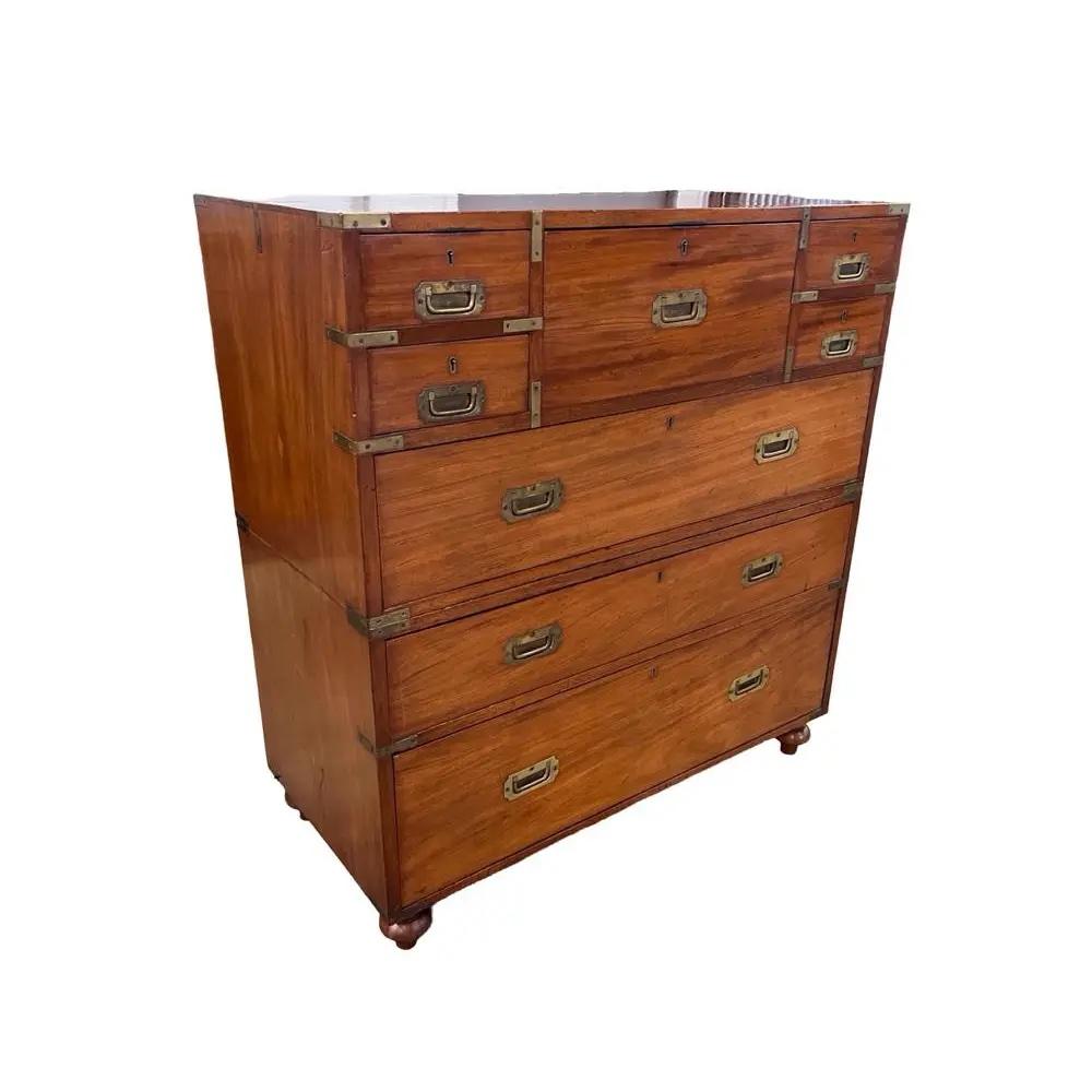 Campaign secretary chest of drawers hand-made in England in the early 1800s using mahogany. This is a beautifully-made chest that serves the function of both a dresser and a writing table. The central drawer on the top flips open and contains three