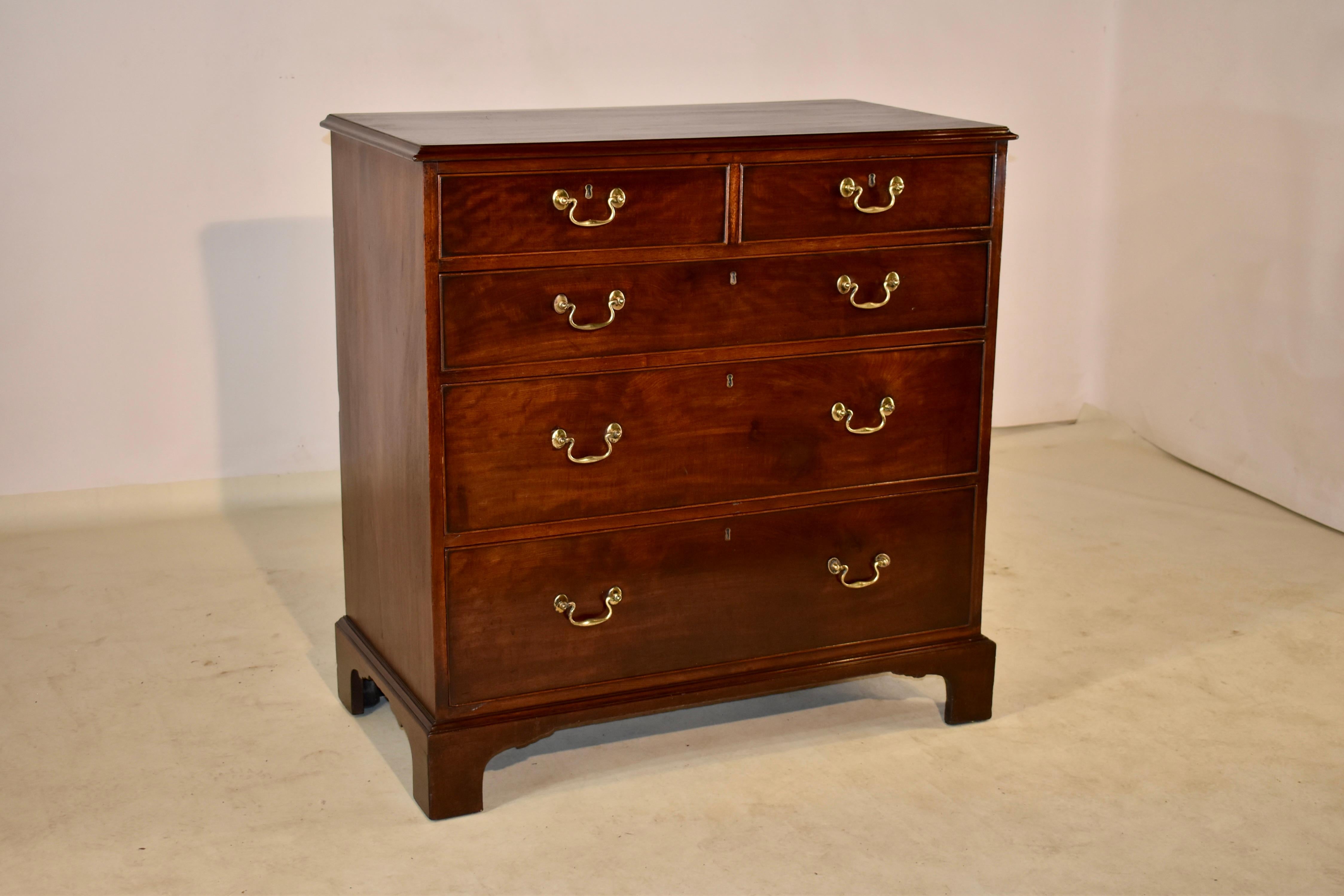 Late 18th-early 19th century period Georgian chest of drawers from England made from mahogany. The top is splendidly grained and follows down to sides which have lovely graining as well. The front of the case has two drawers over three drawers. The