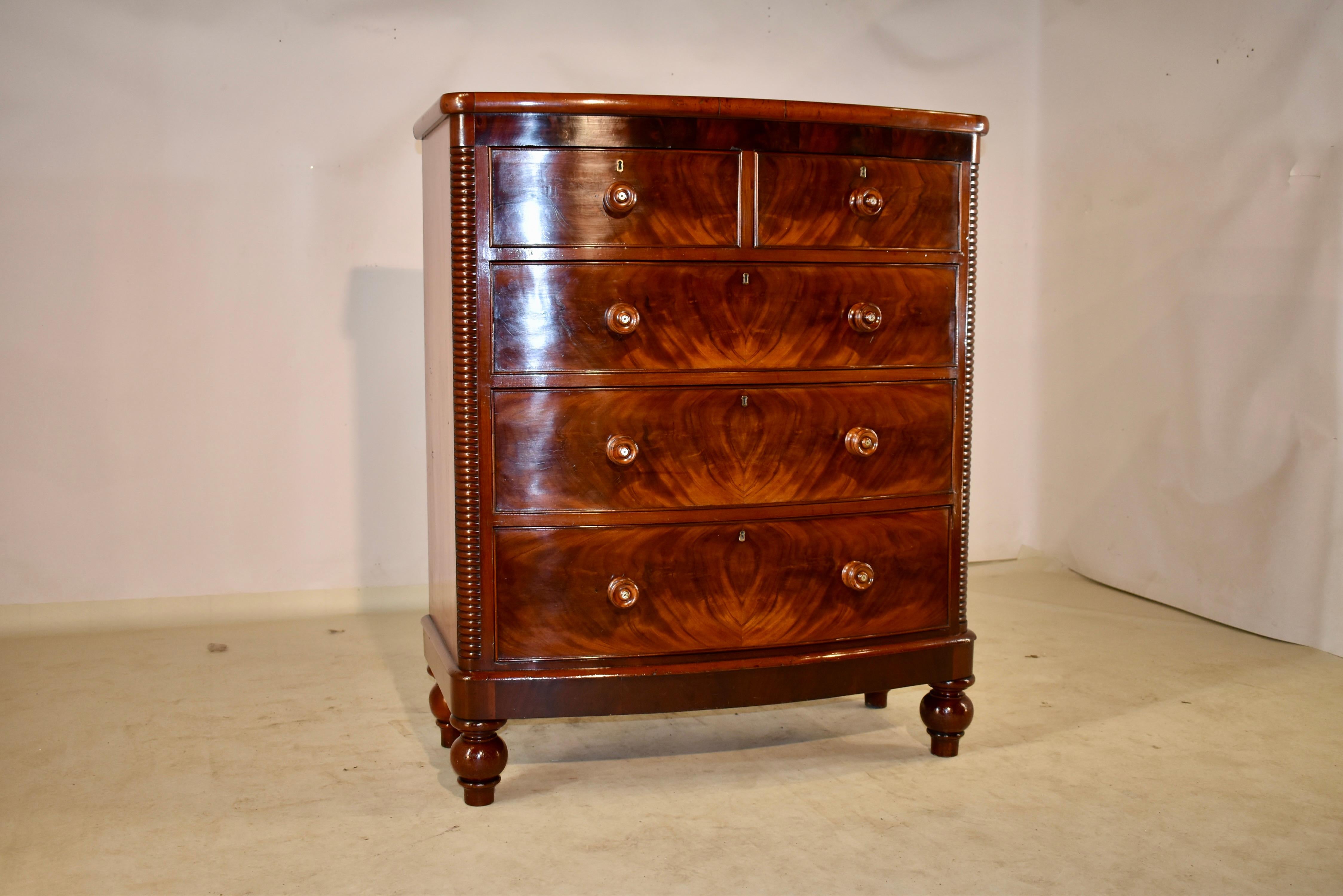 19th Century mahogany tall chest of drawers from England. The top is wonderfully grained and follows down to simple sides and two drawers over three drawers in the front. The drawer fronts are beaded and are made from flame mahogany for a wonderful
