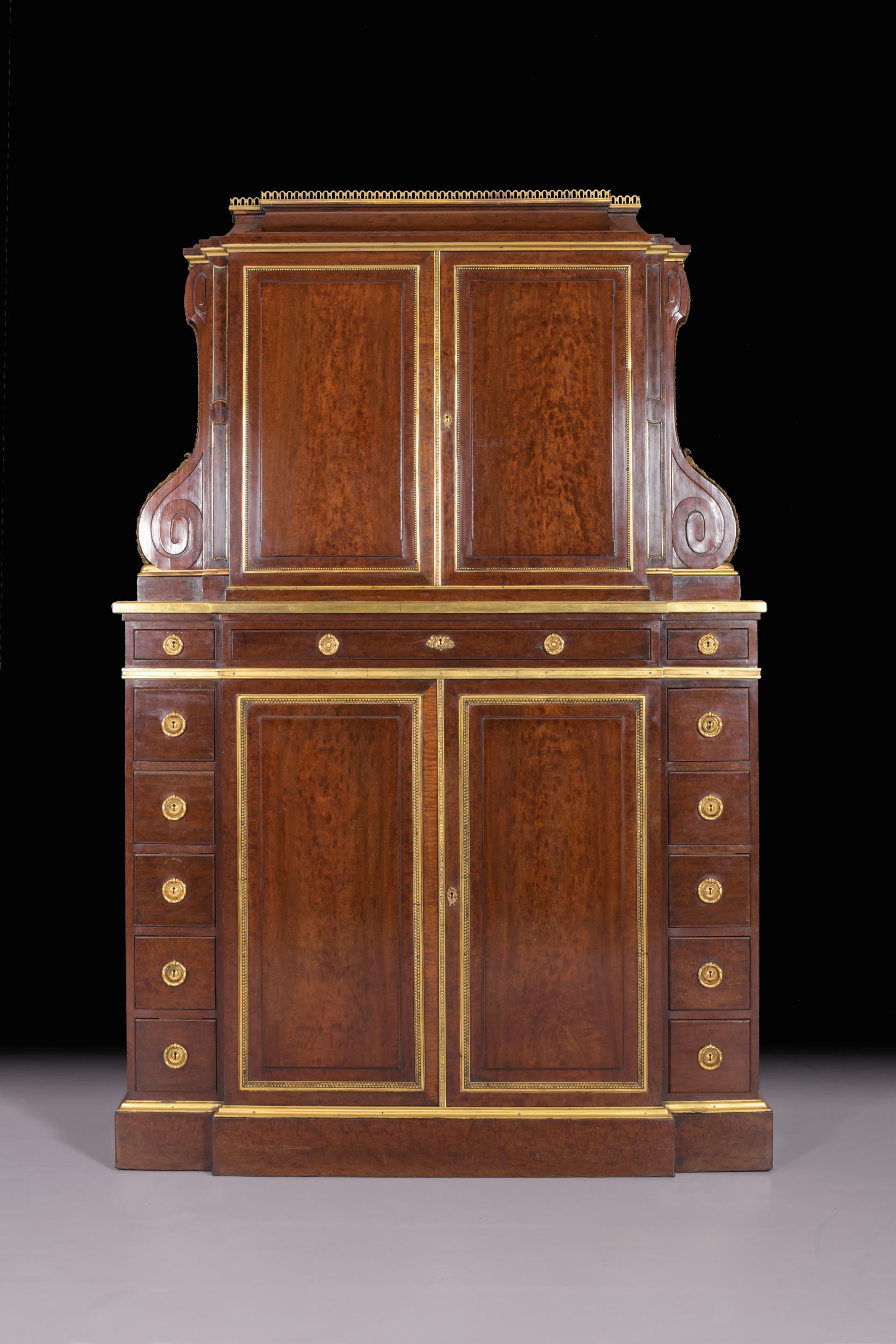 A superb quality plum mahogany and ormolu mounted breakfront collectors / side cabinet. The pierced brass gallery top, above two panelled doors having gilt bronze beaded frames which opens to disclose a shelved fitted interior, flanked by superb