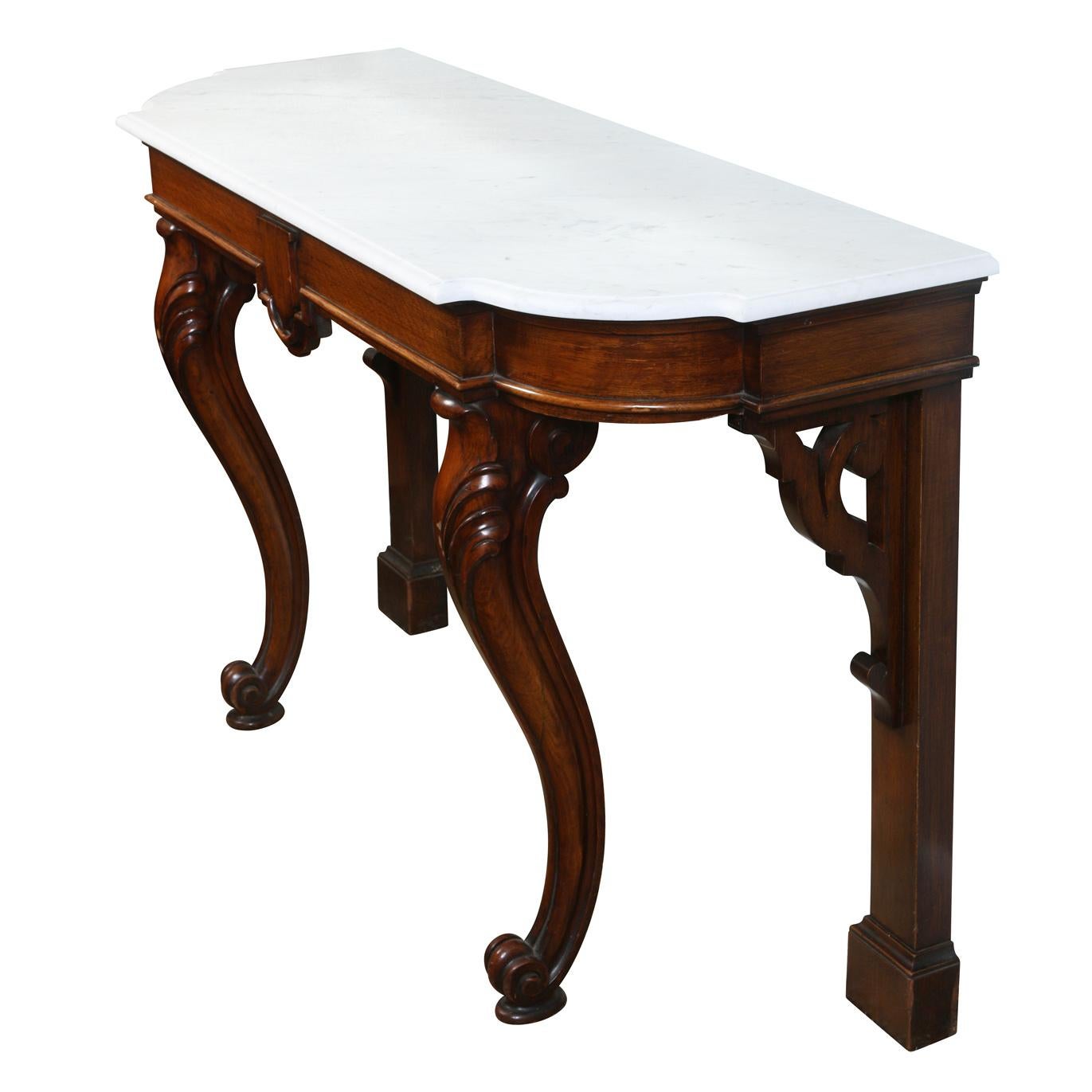 A 19th Century English mahogany console table with shaped marble top, cabriole front legs and carved shield to apron.