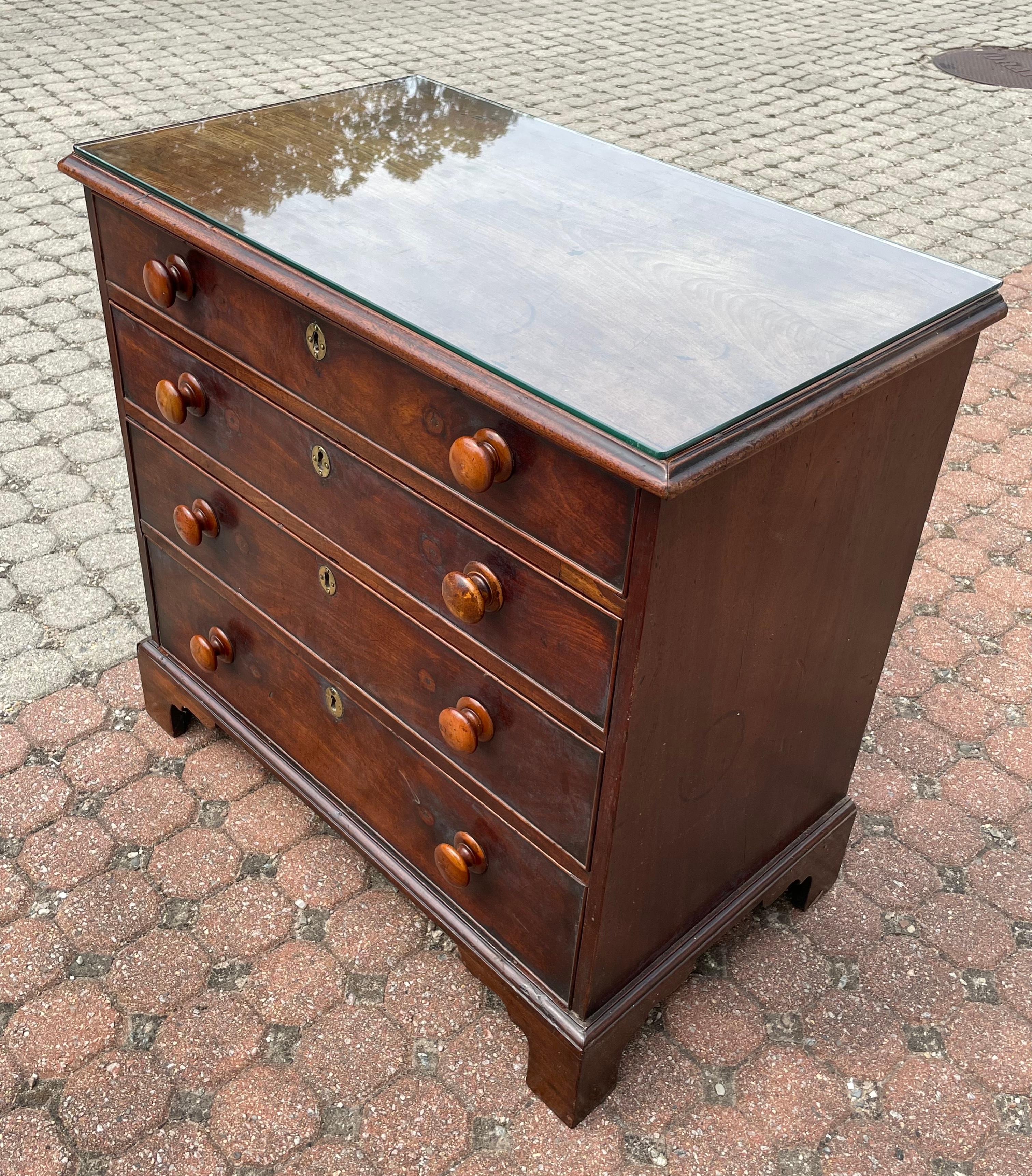 19th c. English Mahogany chest of four graduated drawers with lovely mellow patina.  Top slightly faded with sun with two old patched repairs.  Upper drawer with dividers creating three sections.  Each drawer with a central brass key escutcheon (no