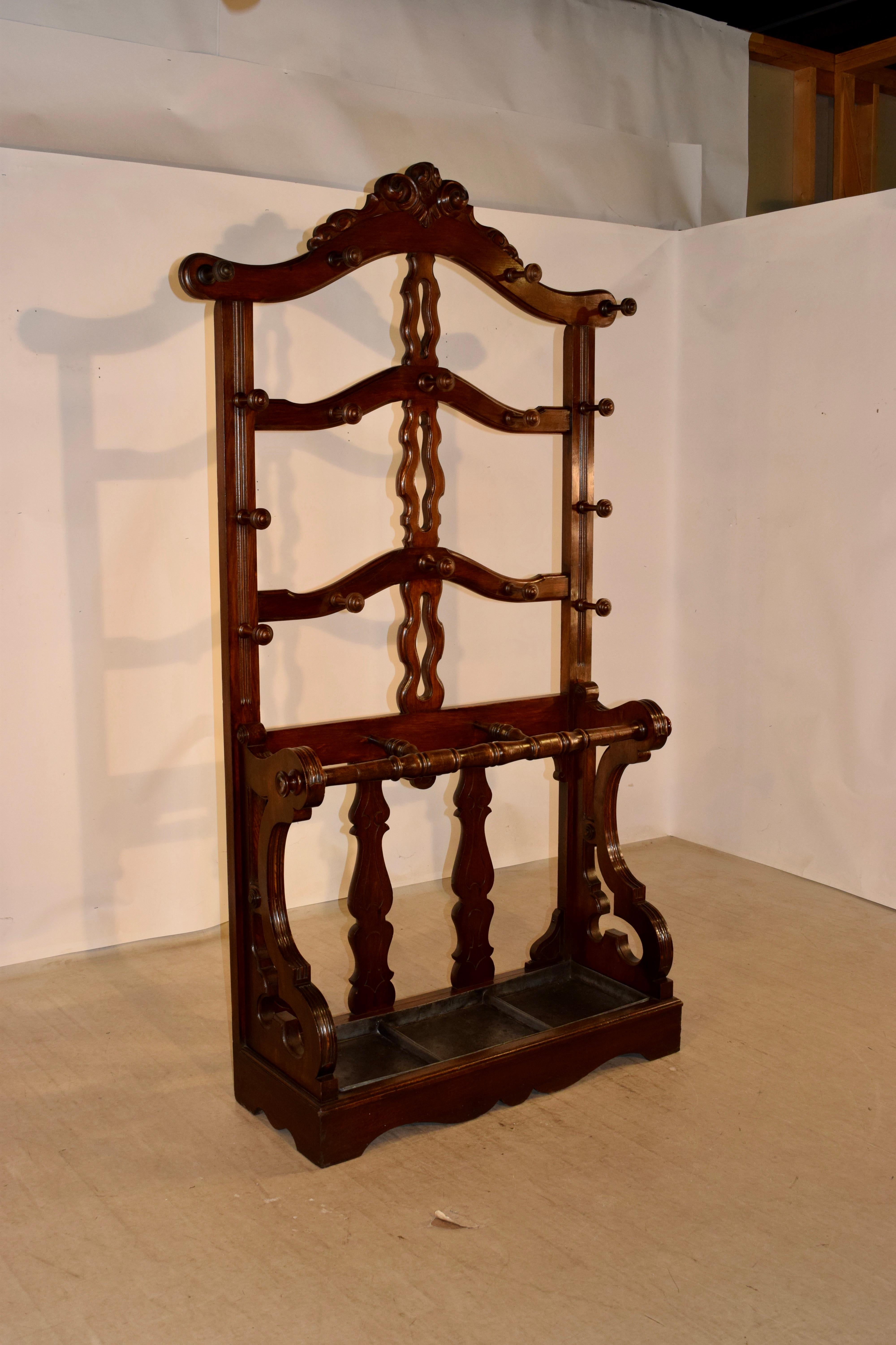 19th century English mahogany hall stand with wonderful shape and carved details. This piece has a lovely profile as well, and would be show-stopping in a stately home. The wood has a beautiful color and the stand has not only a gracious space for